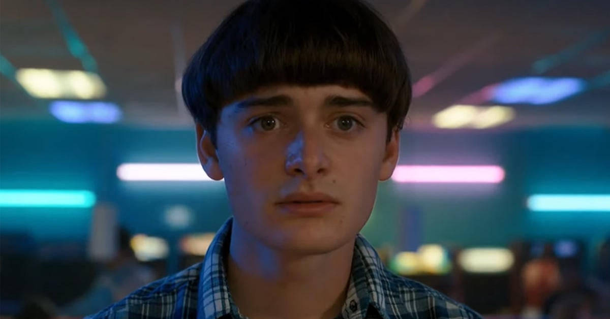 Noah Schnapp, neon-lit arcade, glowing blue and pink lights, SD Desktop Wallpaper