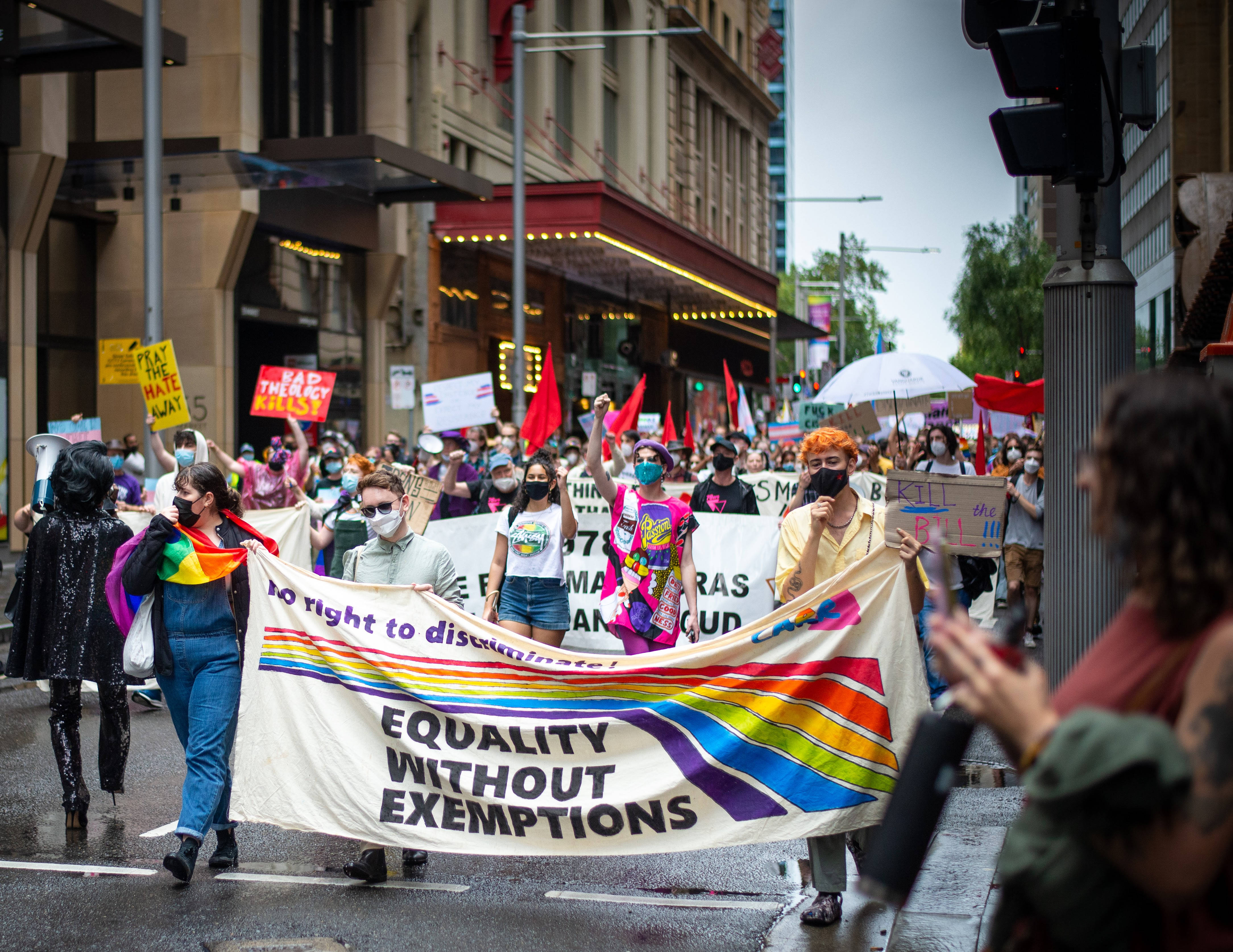 LGBTQ+ pride march, rainbow banners, wet city street, 4K Desktop Wallpaper