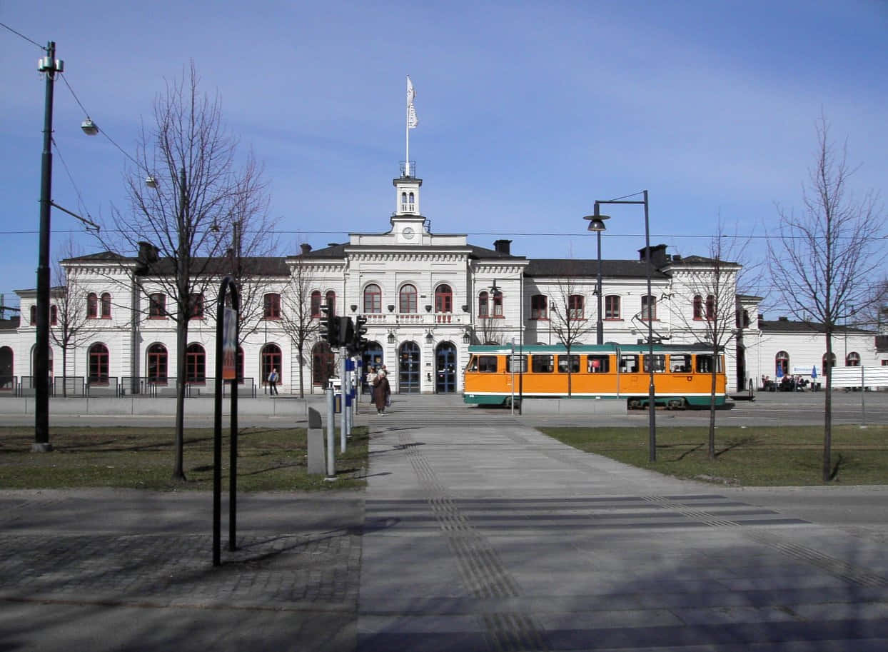 Norrköping, bright orange tram, grand white historic station, SD Desktop Wallpaper