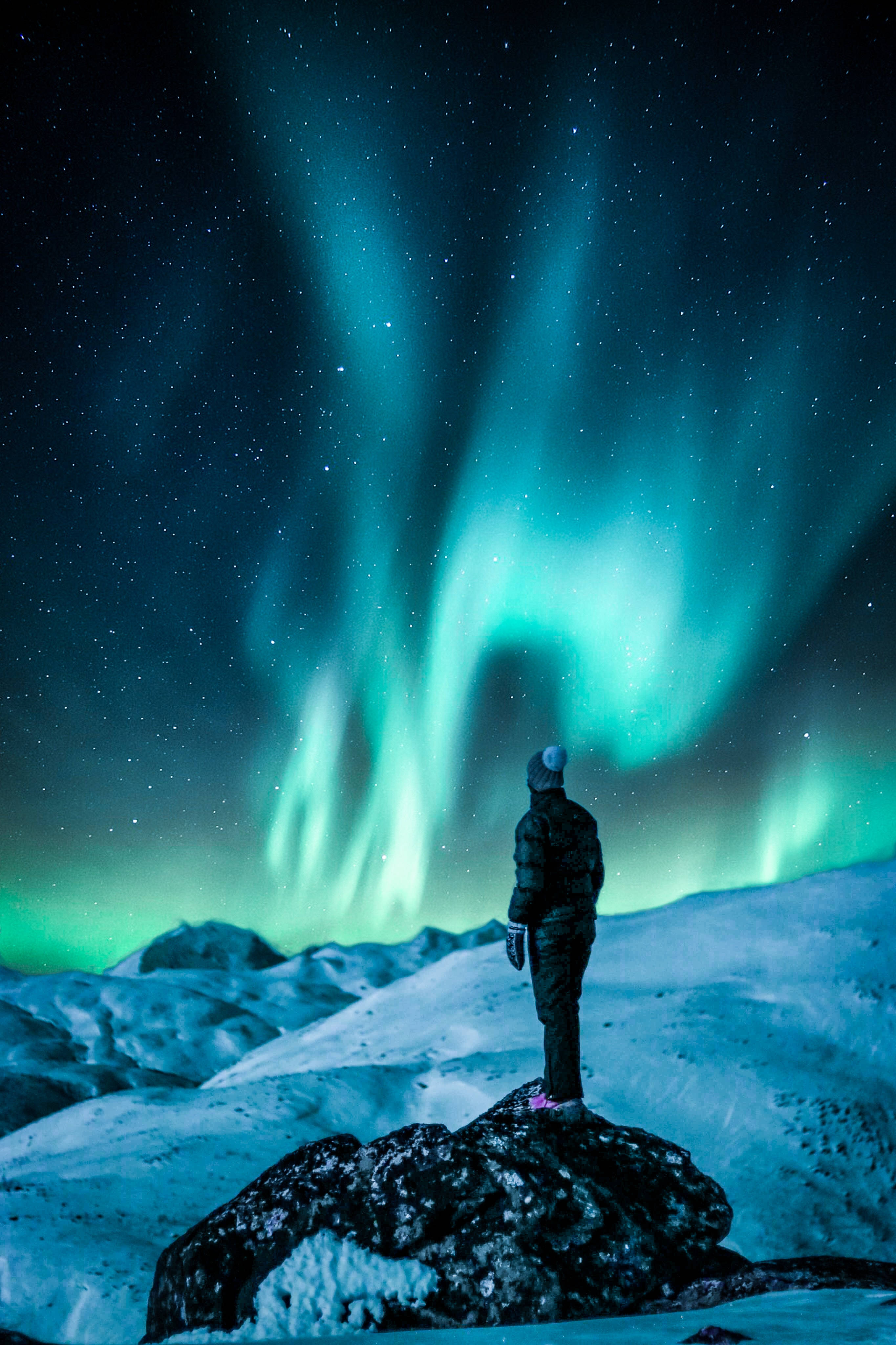 Northern Lights, snowy rock, vibrant green, 4K Phone Wallpaper