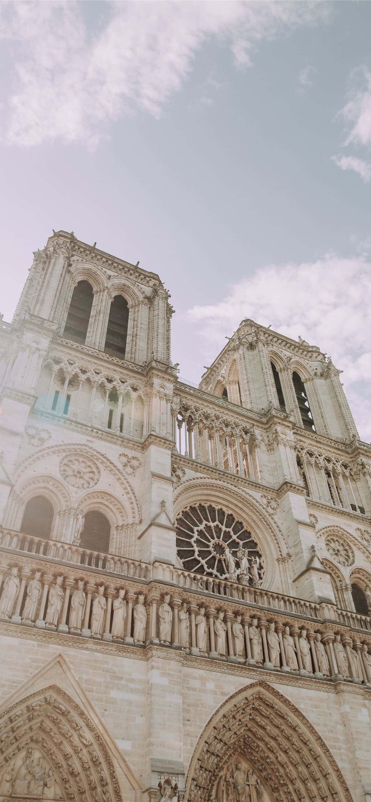 Notre Dame Cathedral, ornate stone facade, rose window, 2K Phone Wallpaper