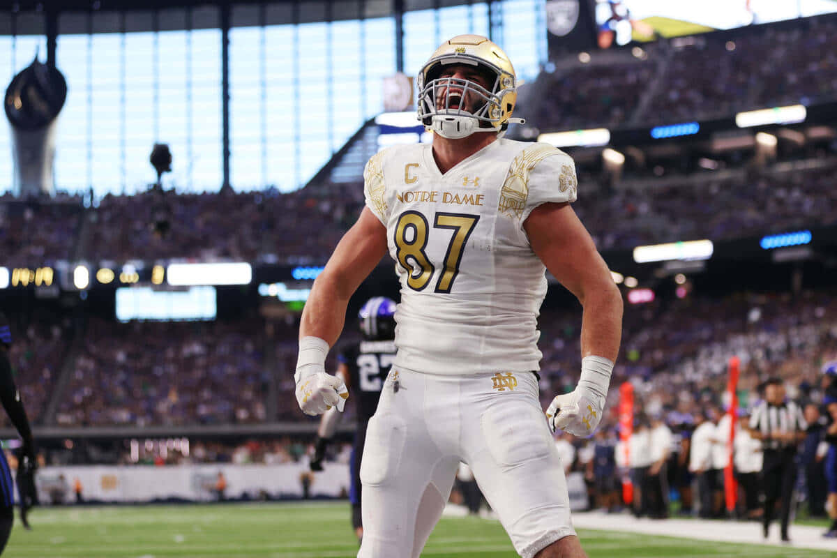 Notre Dame football player, white and gold uniform, night game, SD Desktop Wallpaper