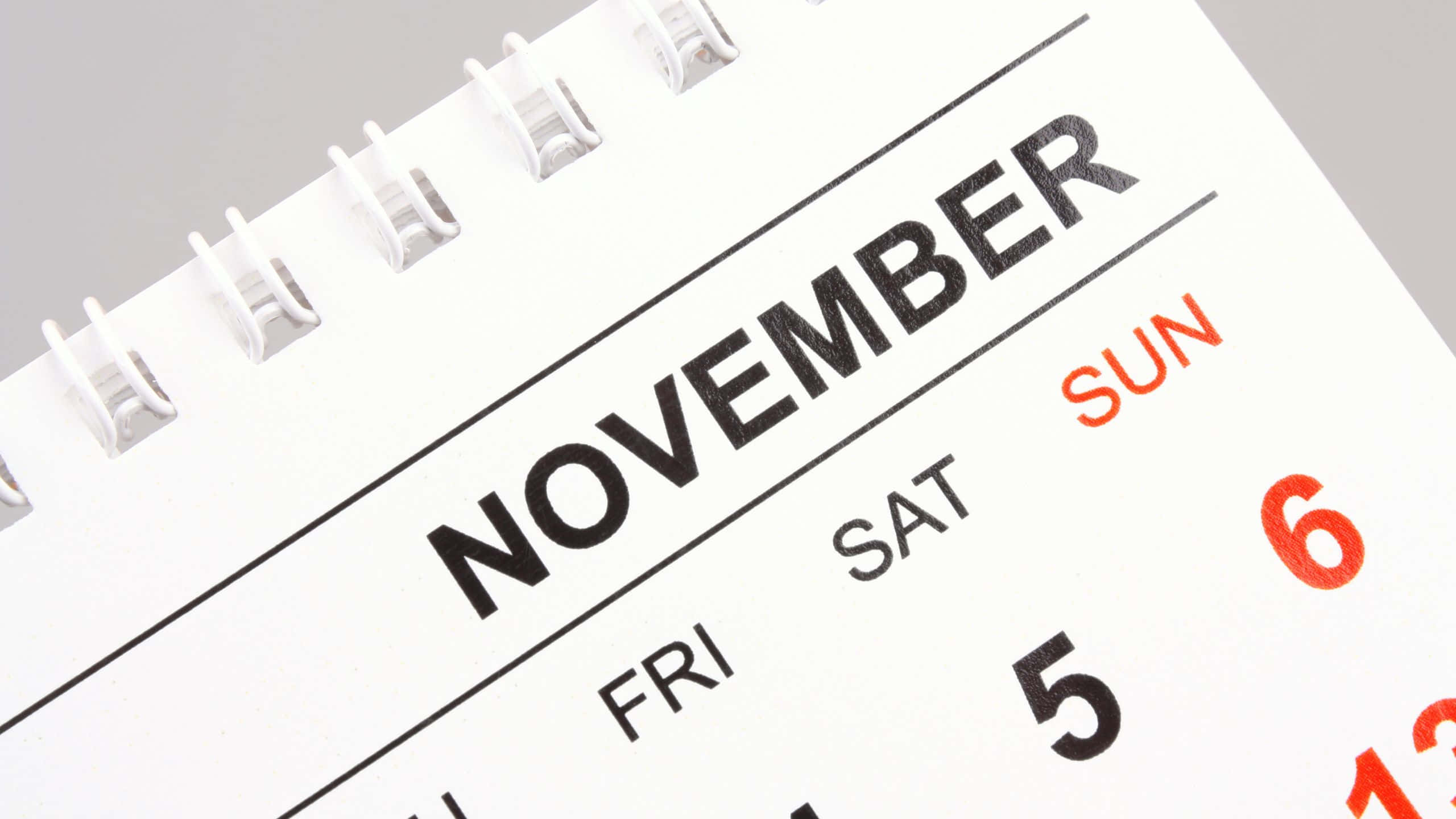 November, white spiral-bound calendar, bold black and red text, 2K Desktop Wallpaper
