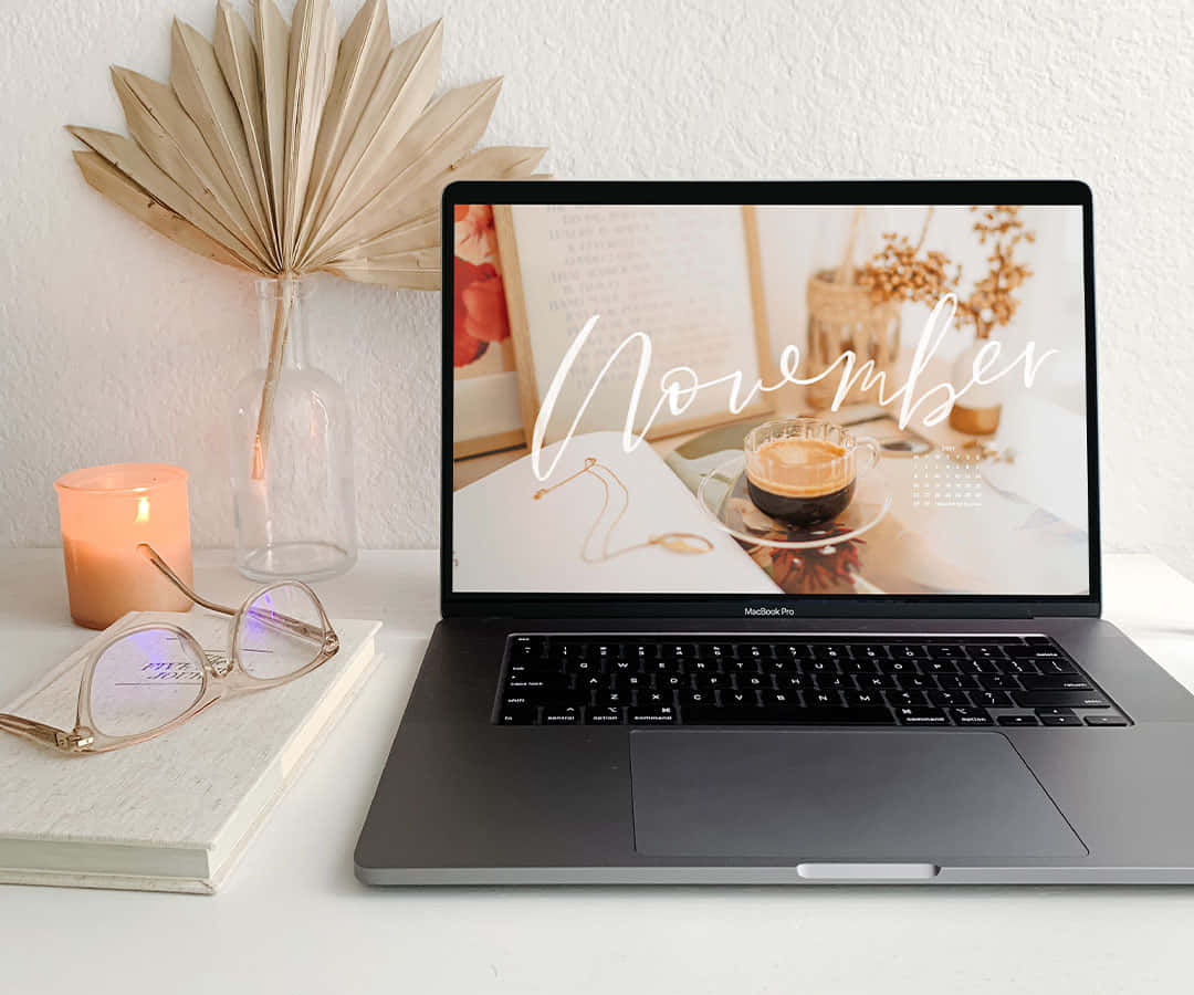 November-themed wallpaper, cozy desk setup, lit candle, SD Desktop Wallpaper
