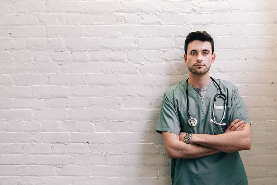 male doctor, green scrubs, white brick wall, SD Desktop Wallpaper