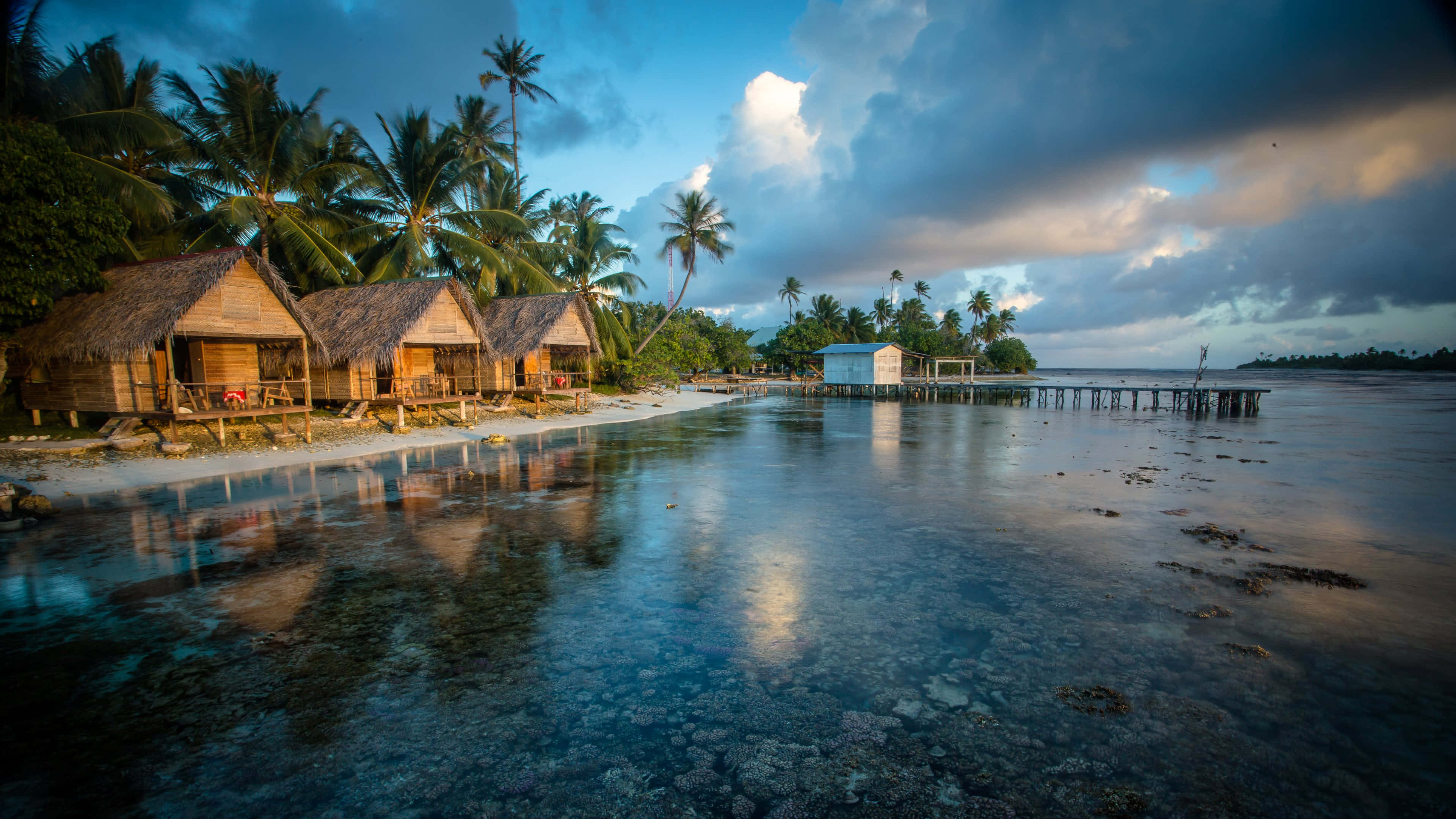 tropical beach huts, thatched roofs, calm turquoise waters, 4K Desktop Wallpaper