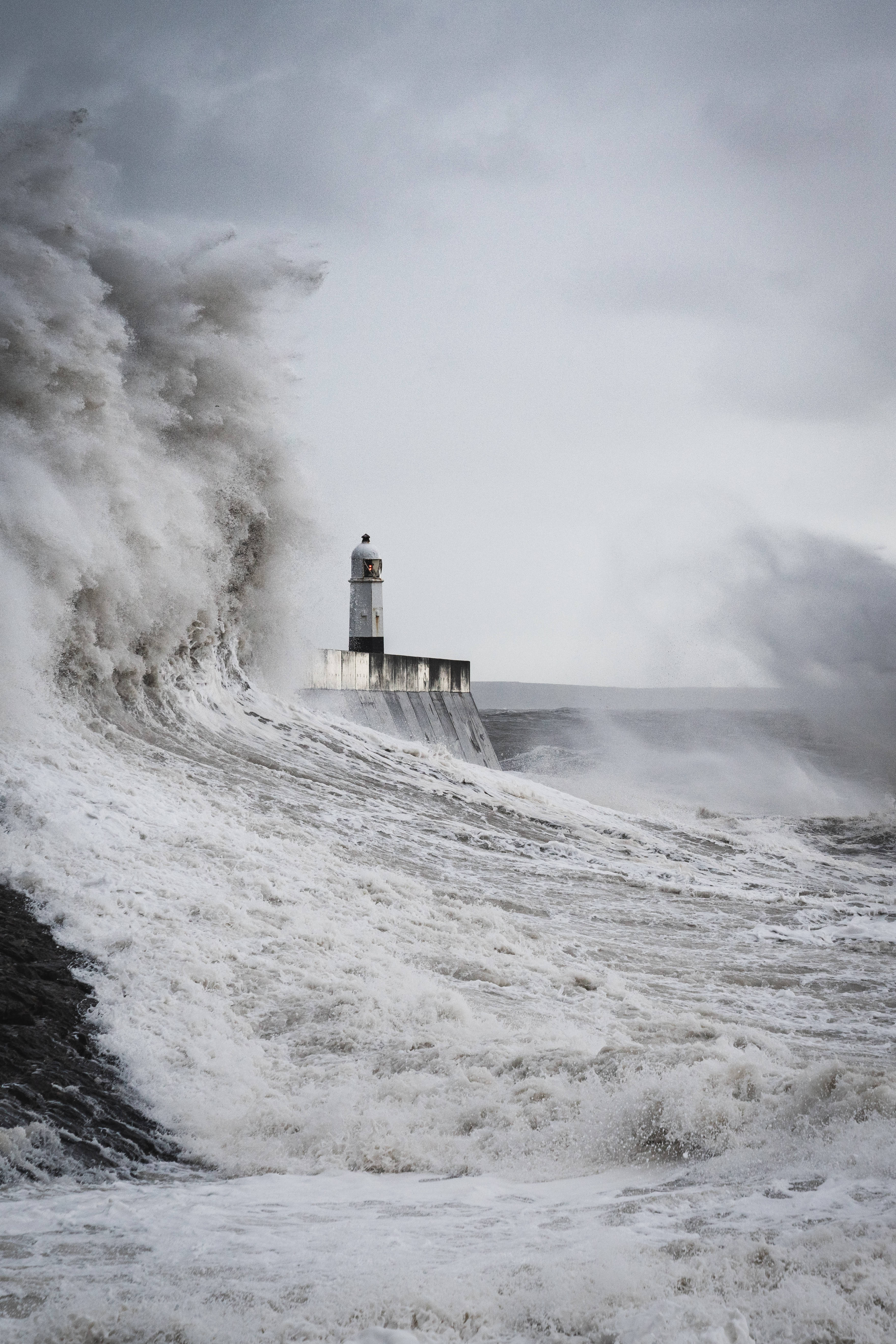 lighthouse, monstrous crashing wave, stormy gray sky, 5K Phone Wallpaper