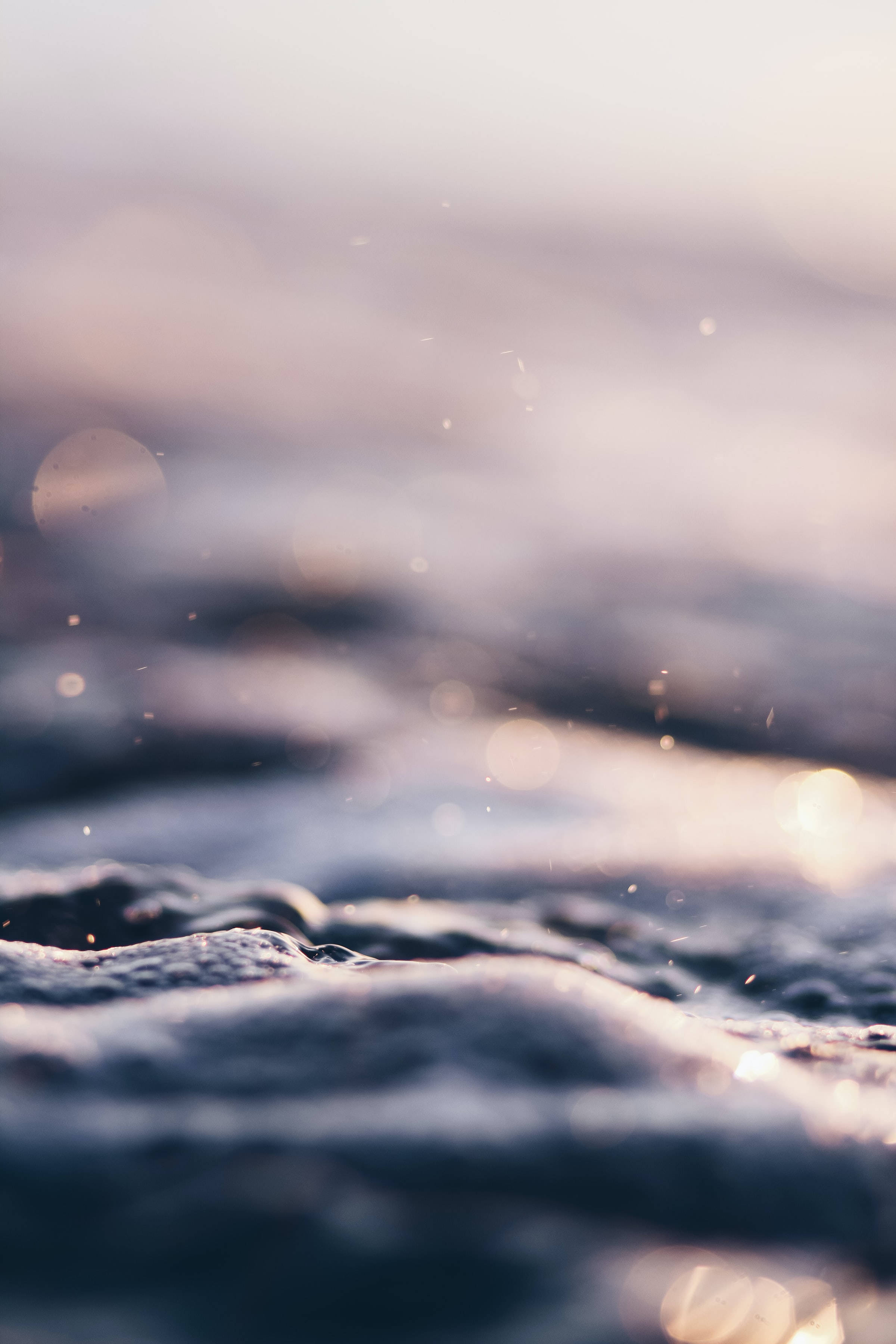 calm small water waves, warm golden light, sparkling bokeh, 2K Phone Wallpaper