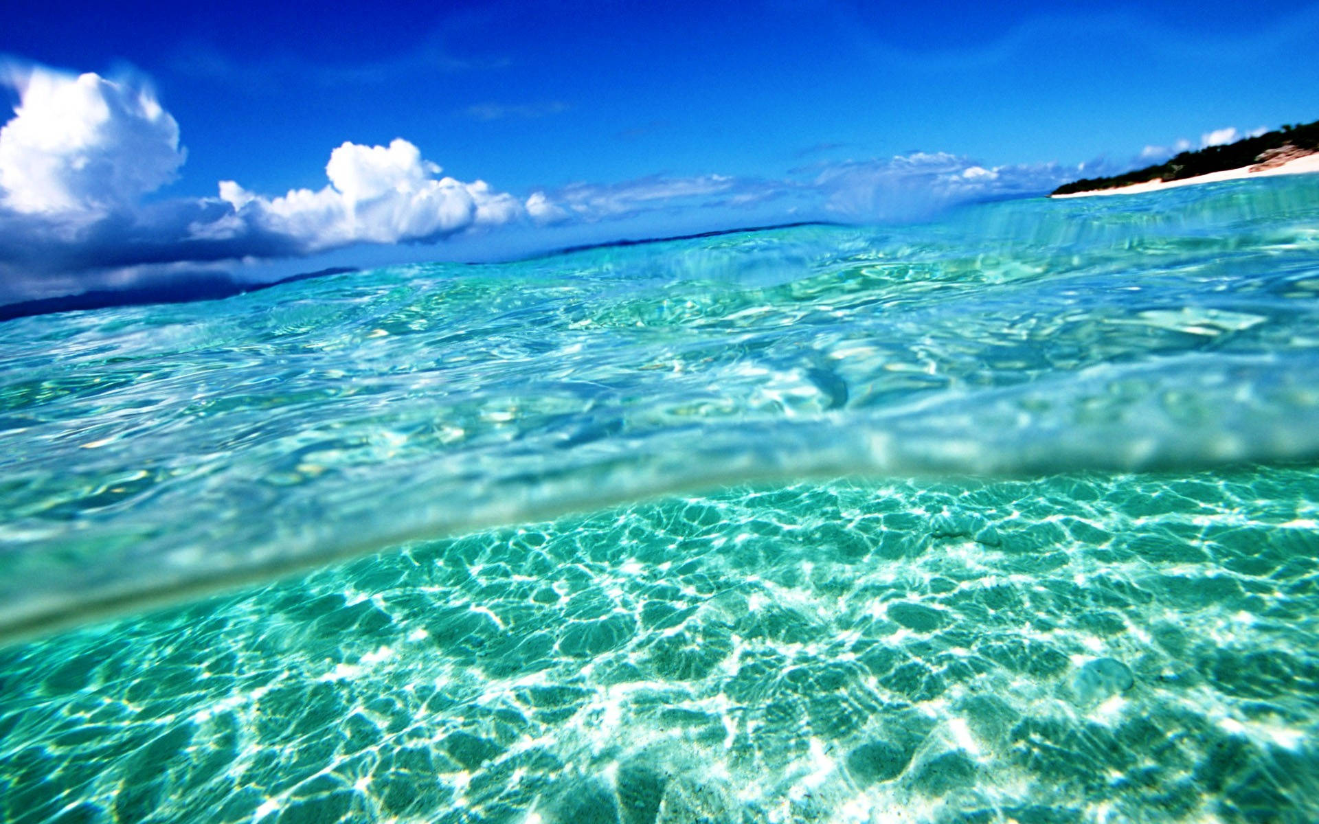crystal clear turquoise ocean water, sunlit ripples, distant sandy shore, Full HD Desktop Wallpaper