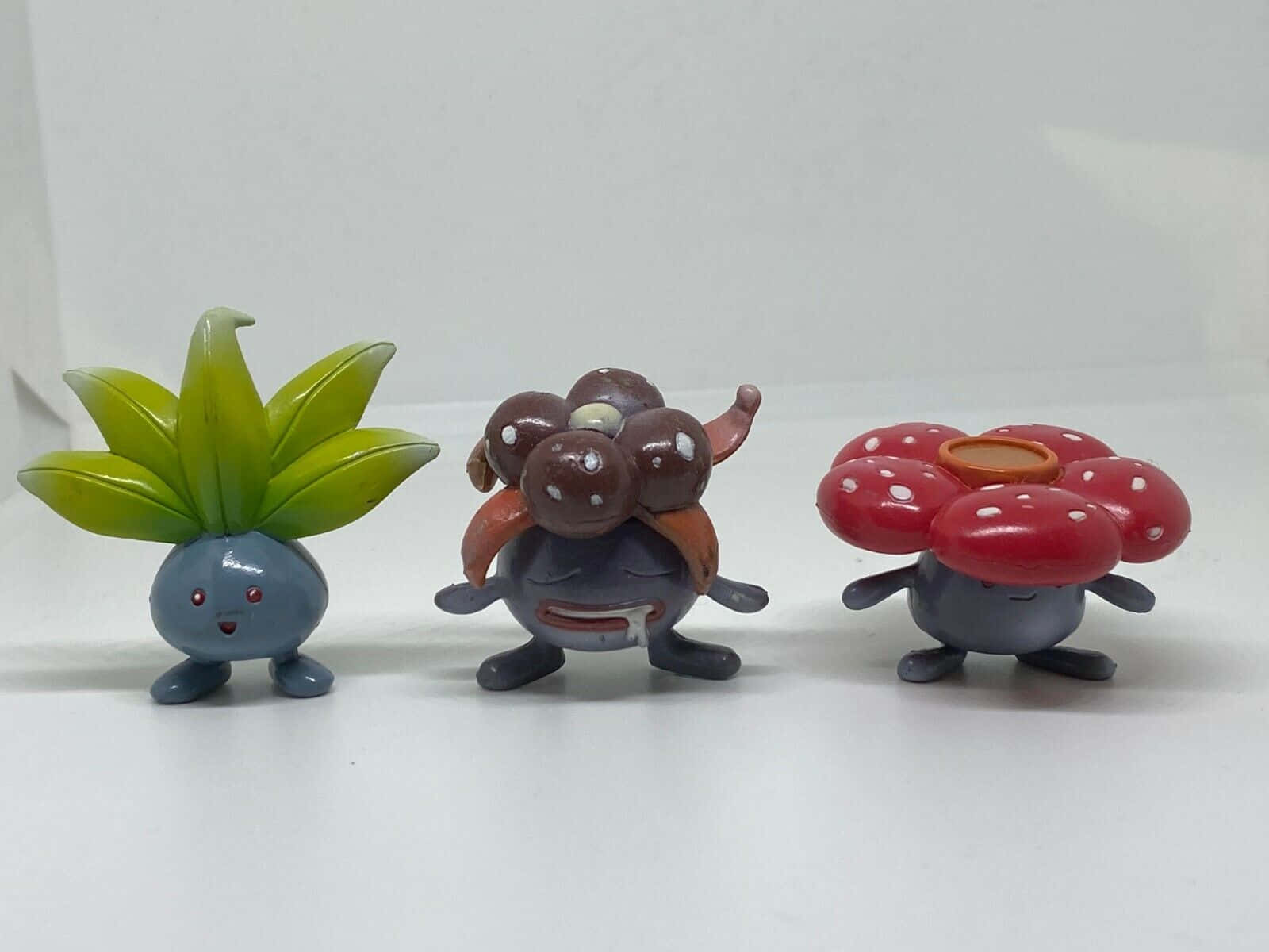 Oddish, Three colorful Pokemon figurines, plain white surface, HD Desktop Wallpaper