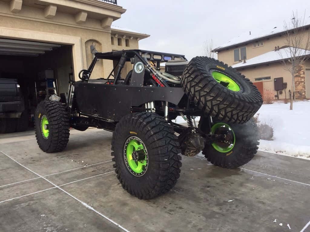 black custom off-road monster truck, neon green wheels, snowy driveway, SD Desktop Wallpaper