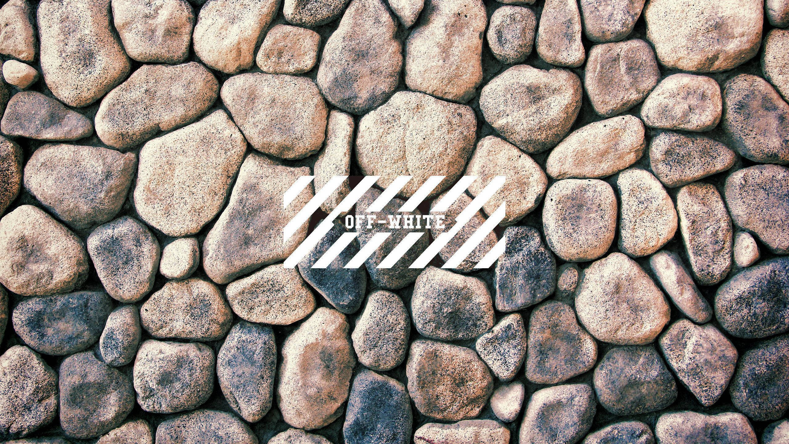 Off White Logo, rustic stone wall, earthy tones, 2K Desktop Wallpaper