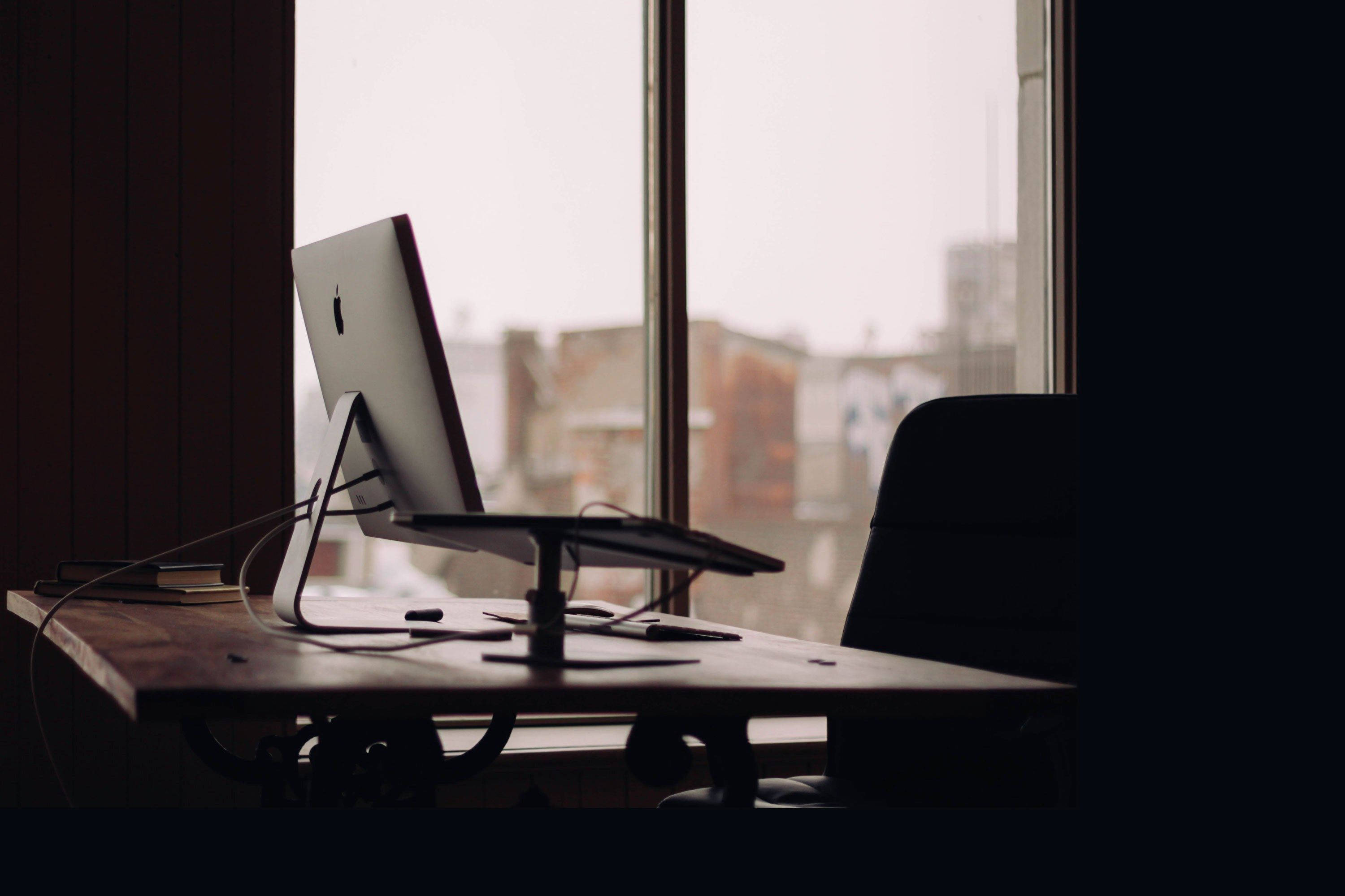 iMac, wooden desk, window, 2K Desktop Wallpaper