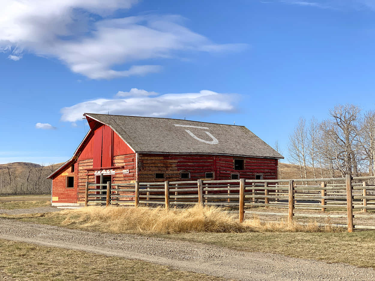 red wooden barn, white 'U' painted on roof, bright blue sky, SD Desktop Wallpaper