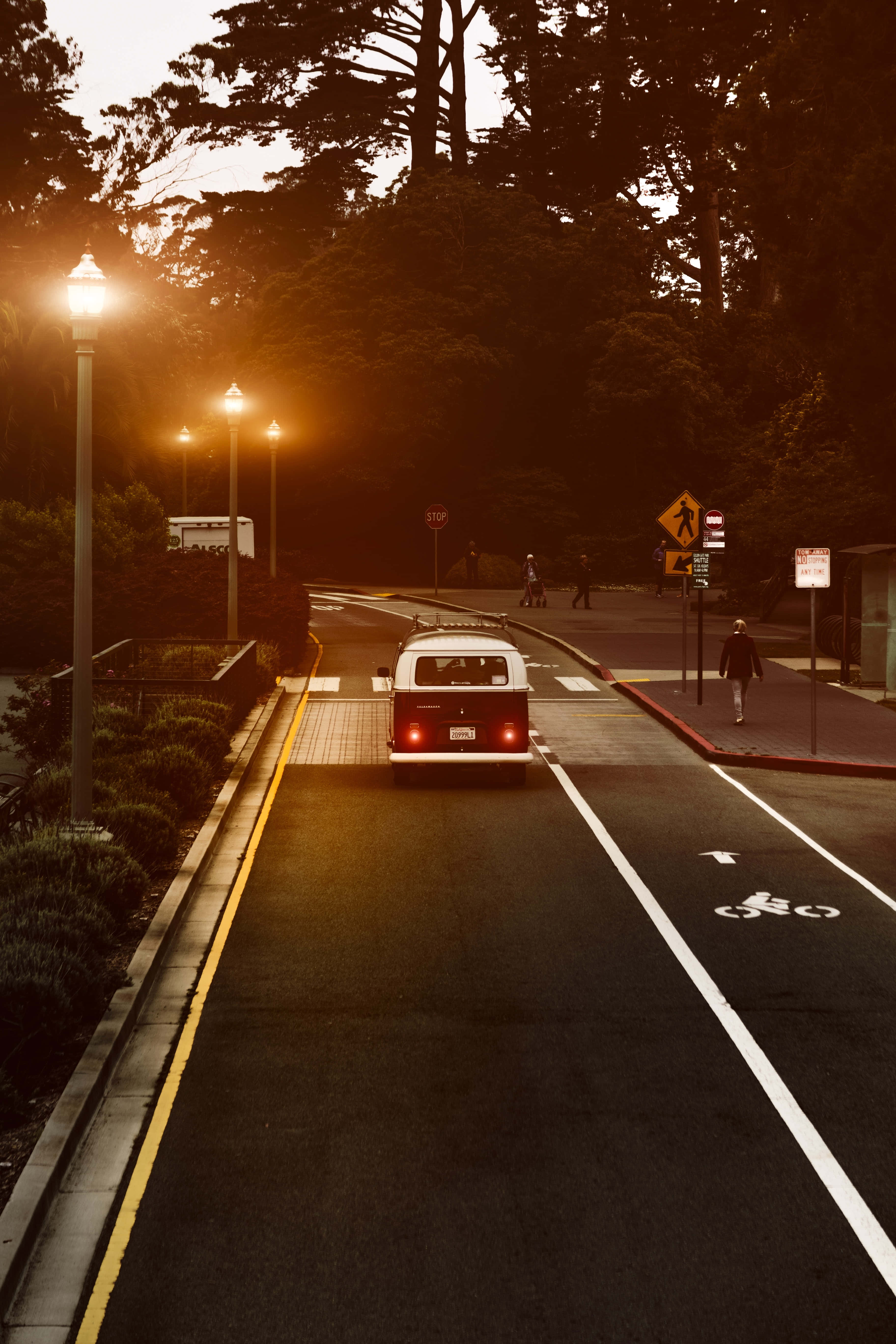 vintage red and white van, tree-lined street, golden hour, 5K Phone Wallpaper