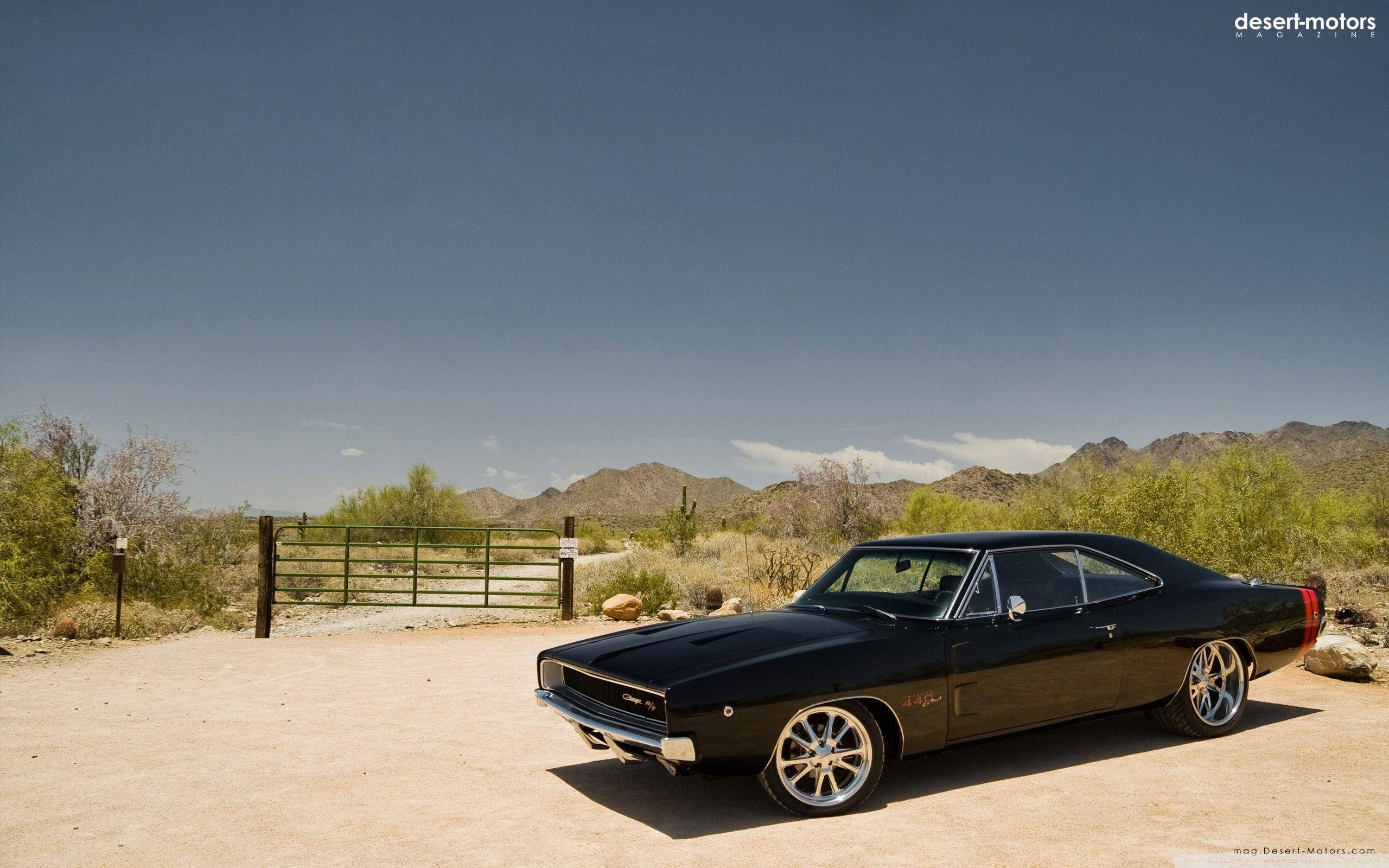sleek black classic muscle car, dusty desert road, distant mountains, 2K Desktop Wallpaper