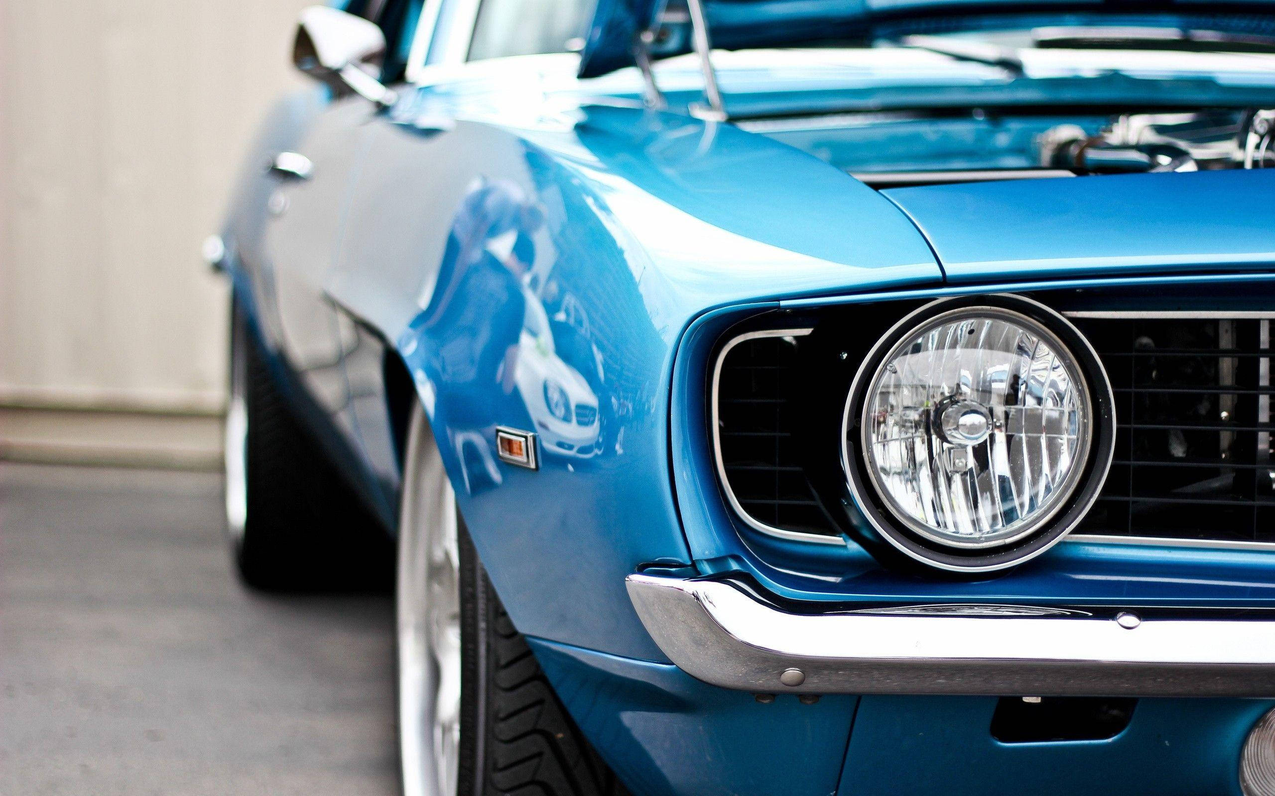 blue classic muscle car, chrome accents, round headlights, 2K Desktop Wallpaper