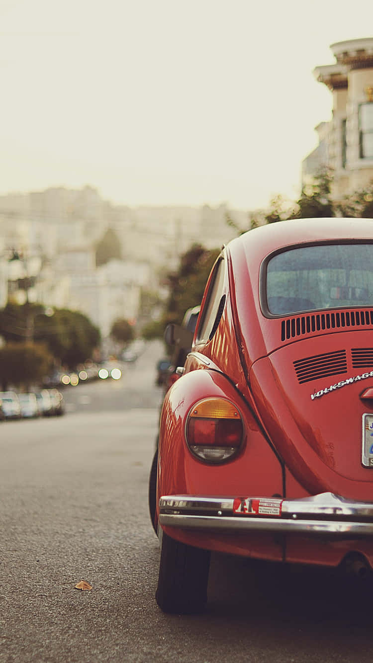 vintage red Volkswagen Beetle, hazy city street, soft golden light, HD Phone Wallpaper