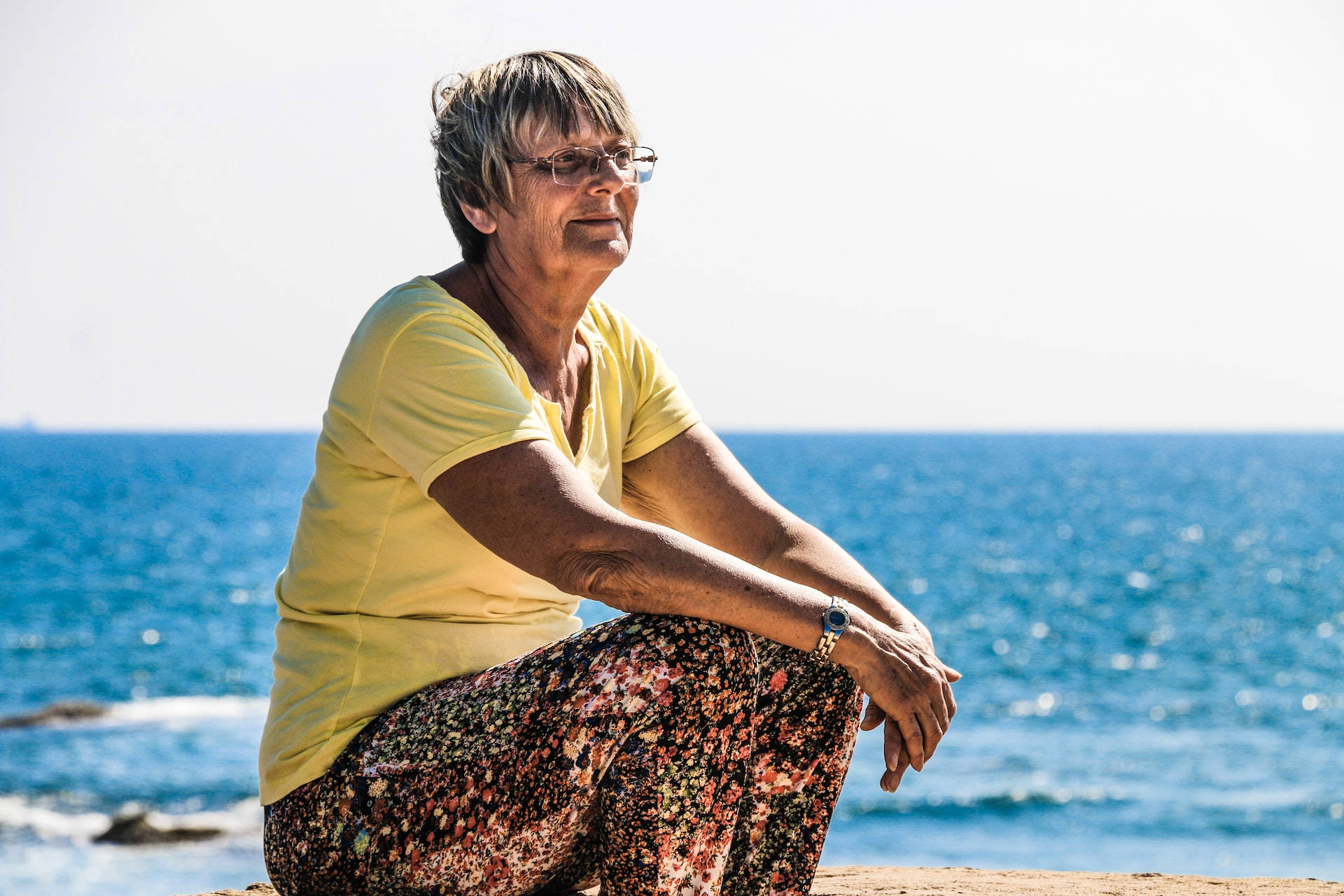 Old Lady, yellow shirt, rocky beach, Full HD Desktop Wallpaper