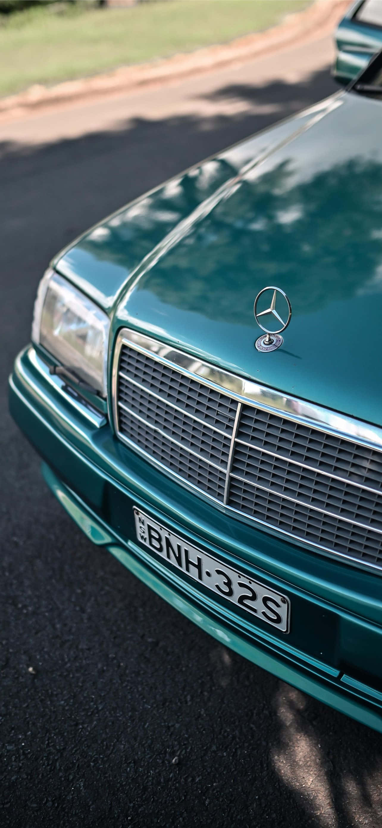 vintage teal Mercedes-Benz car hood, chrome grille, star emblem, 2K Phone Wallpaper