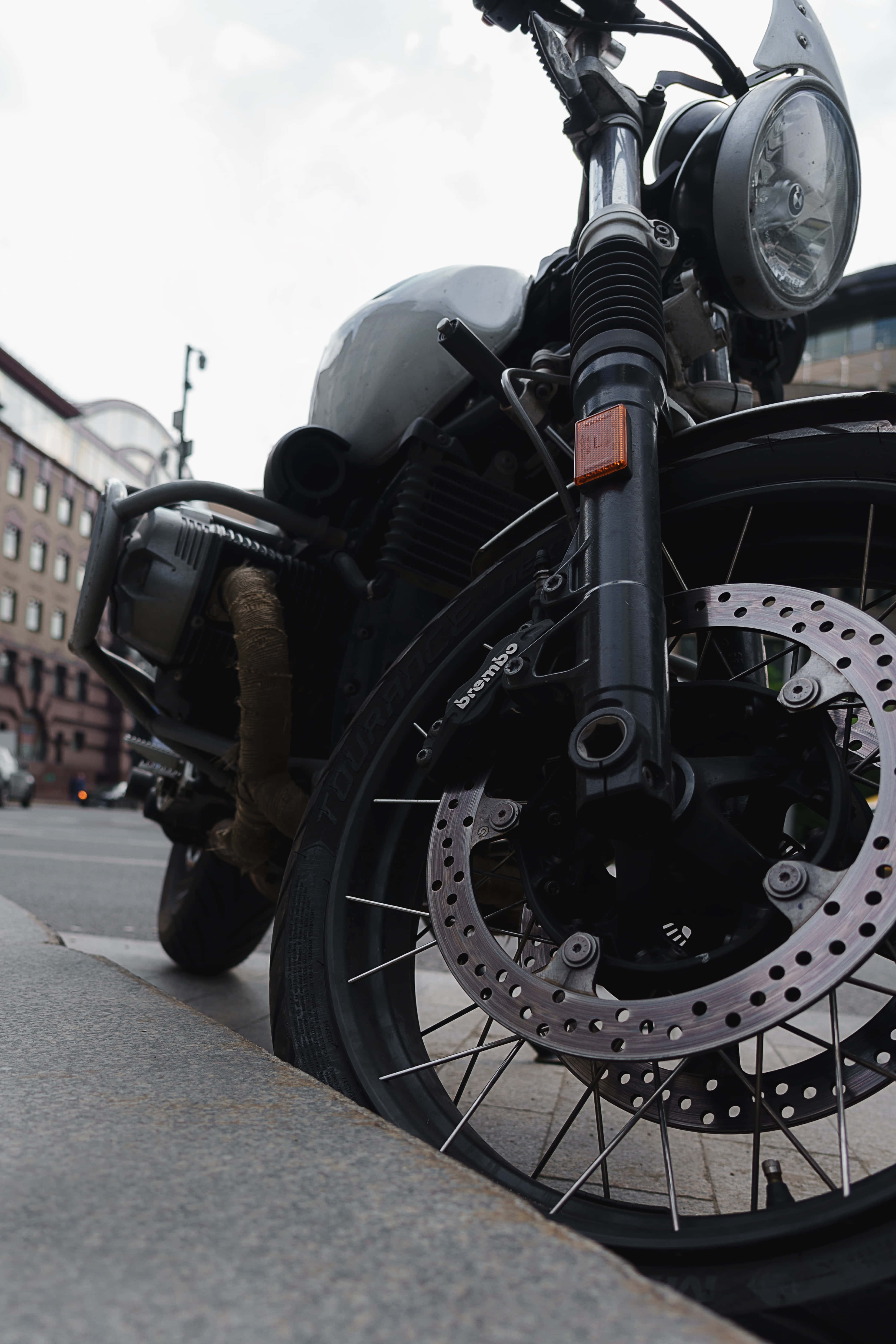 sleek black motorcycle, city sidewalk, urban buildings, 4K Phone Wallpaper
