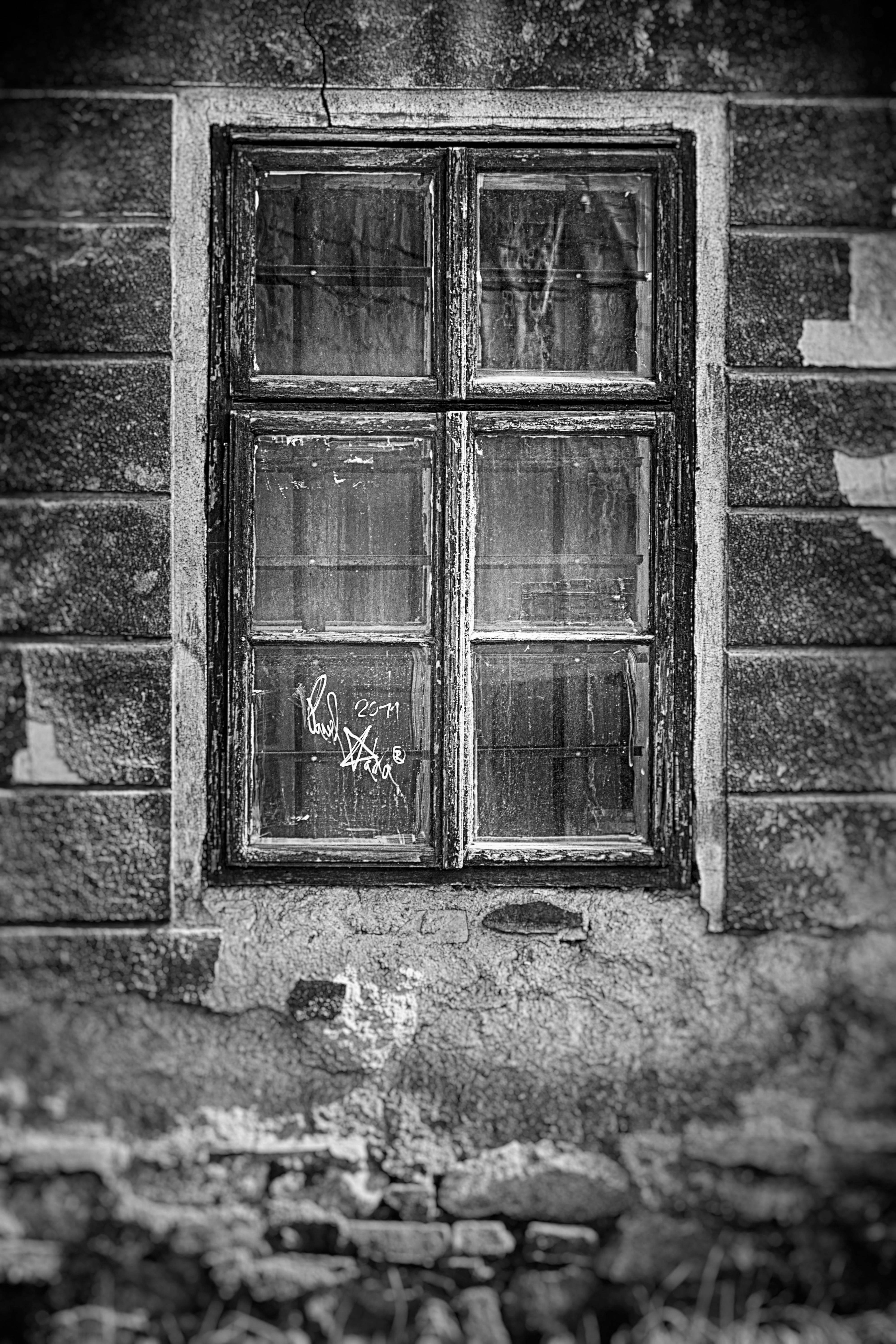 black and white window, graffiti on its glass, crumbling stone wall, 5K Phone Wallpaper