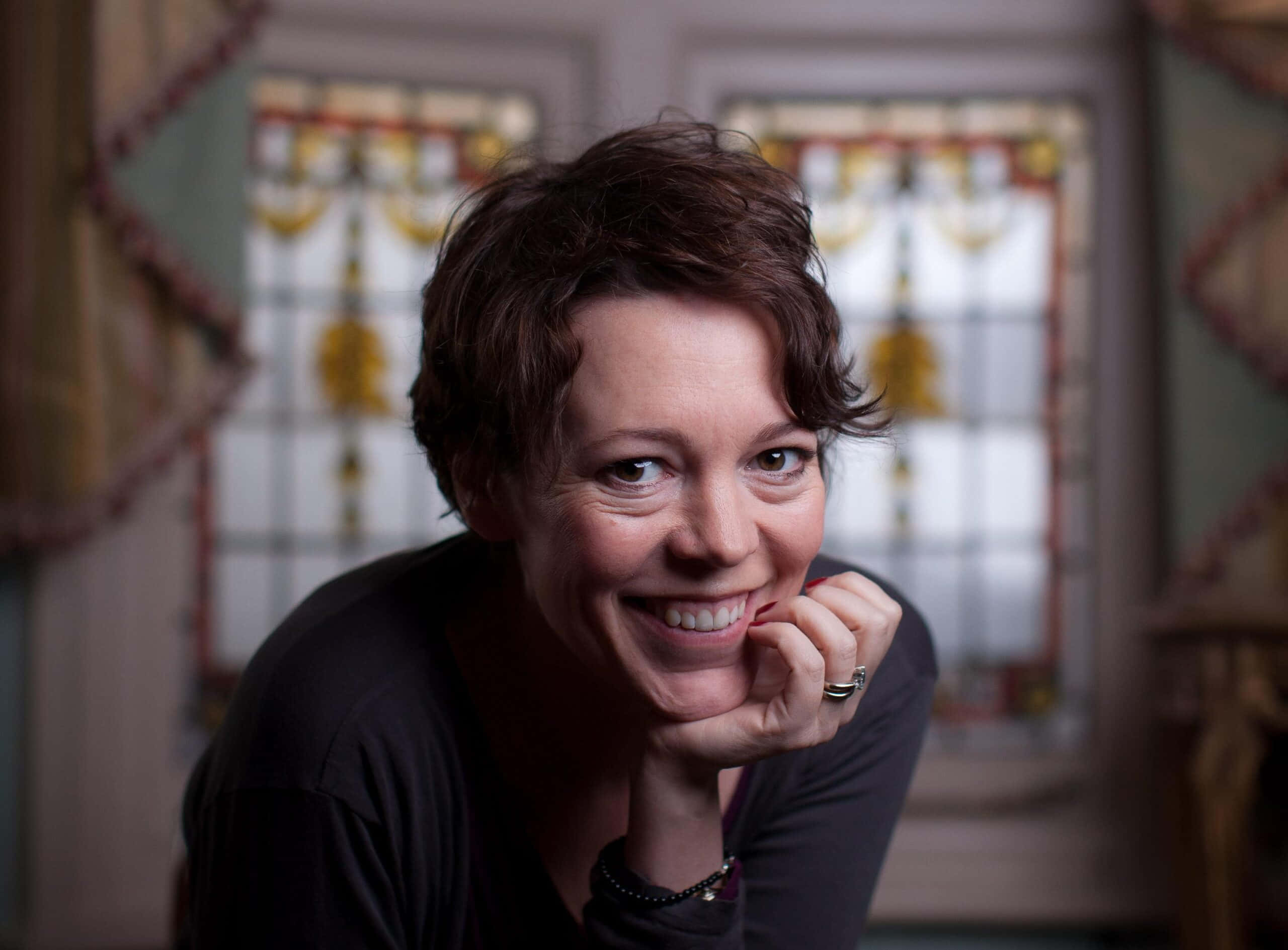 Olivia Colman, stained glass windows, short brown hair, 2K Desktop Wallpaper