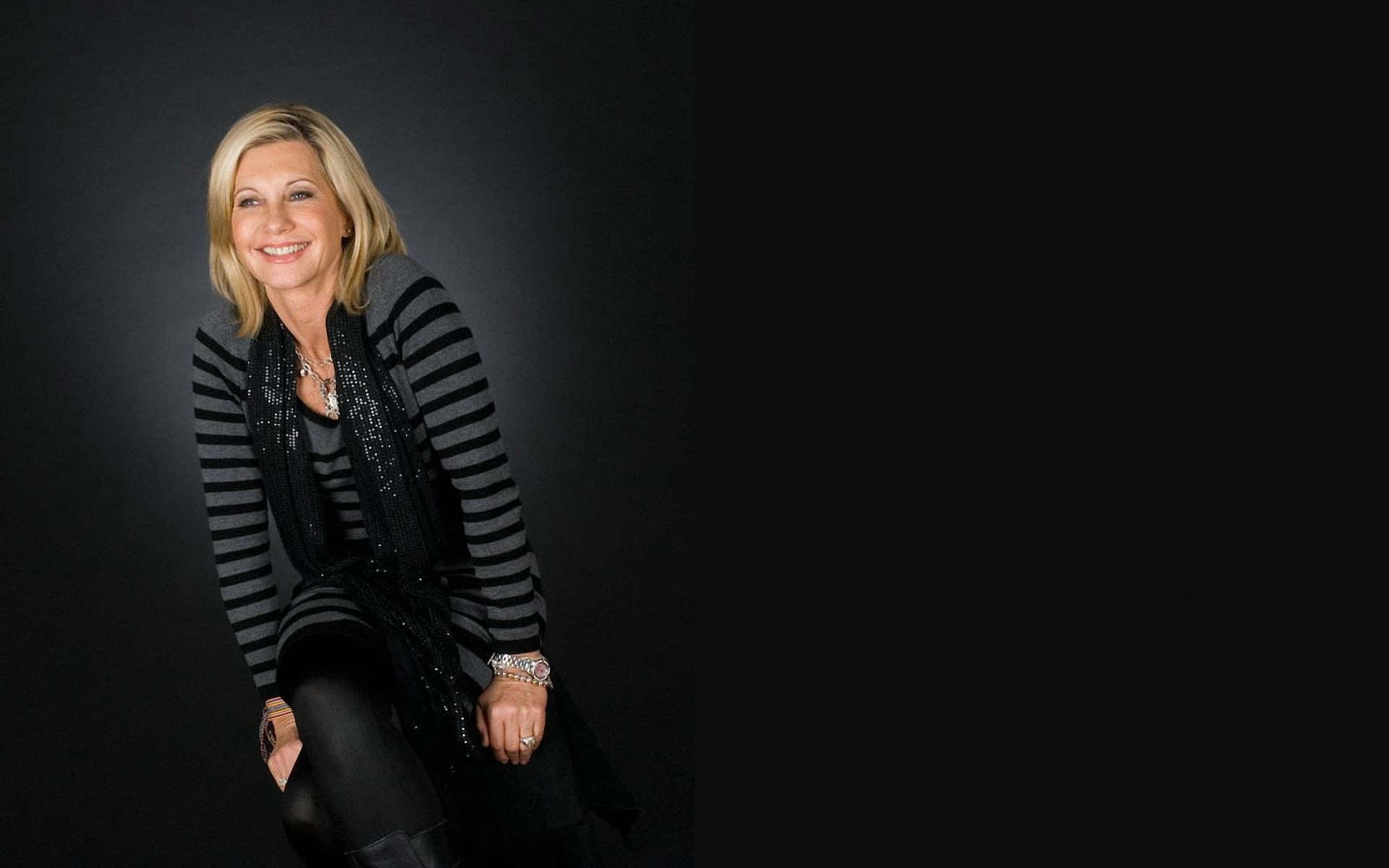 Olivia Newton John, black and gray striped cardigan, dark studio backdrop, Full HD Desktop Wallpaper