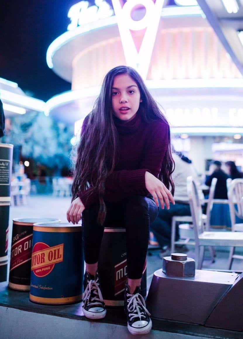 Olivia Rodrigo, neon-lit diner, vintage motor oil cans, SD Phone Wallpaper