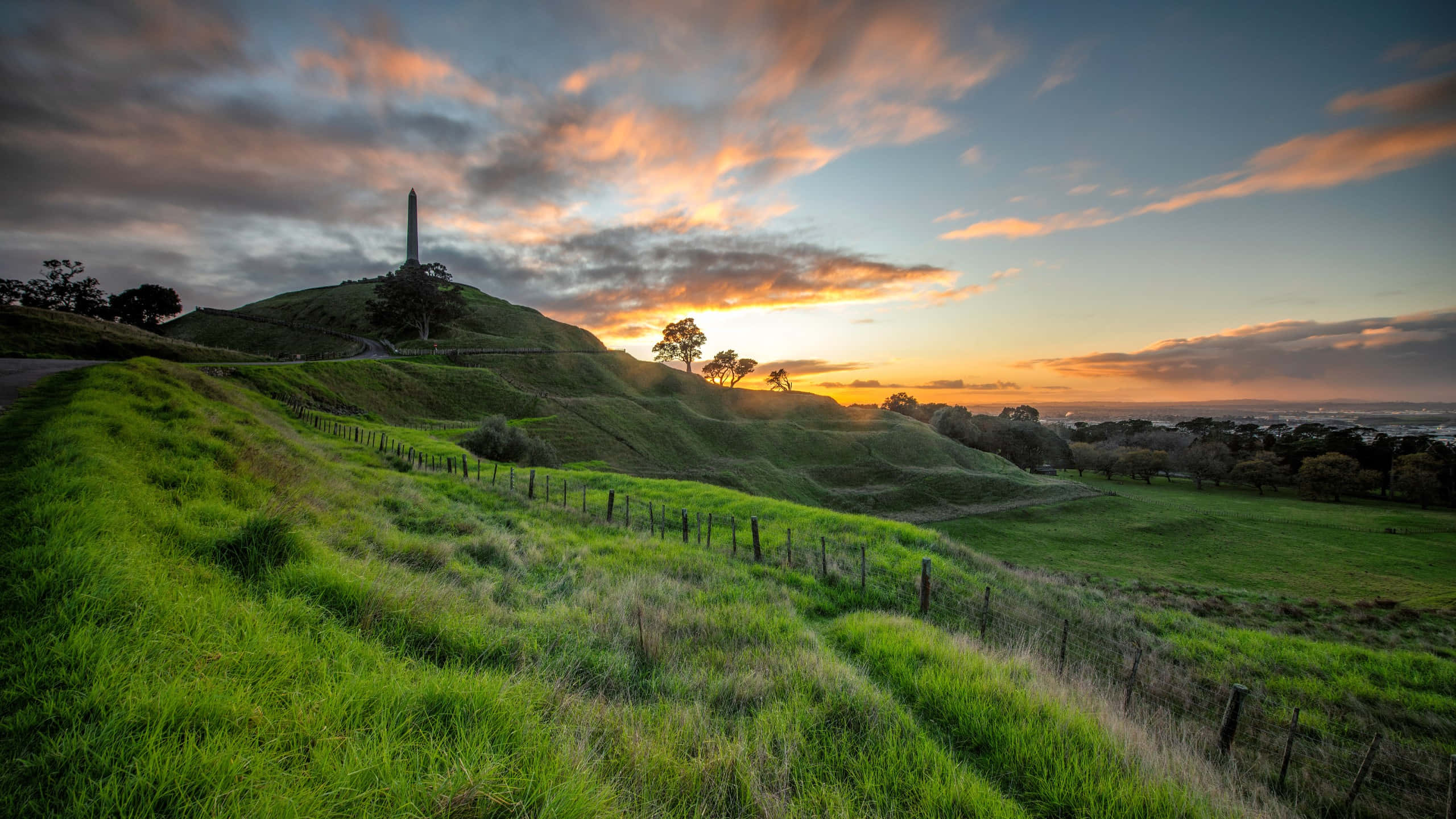 One Tree Hill Auckland, sunset, vibrant green hillside, 2K Desktop Wallpaper