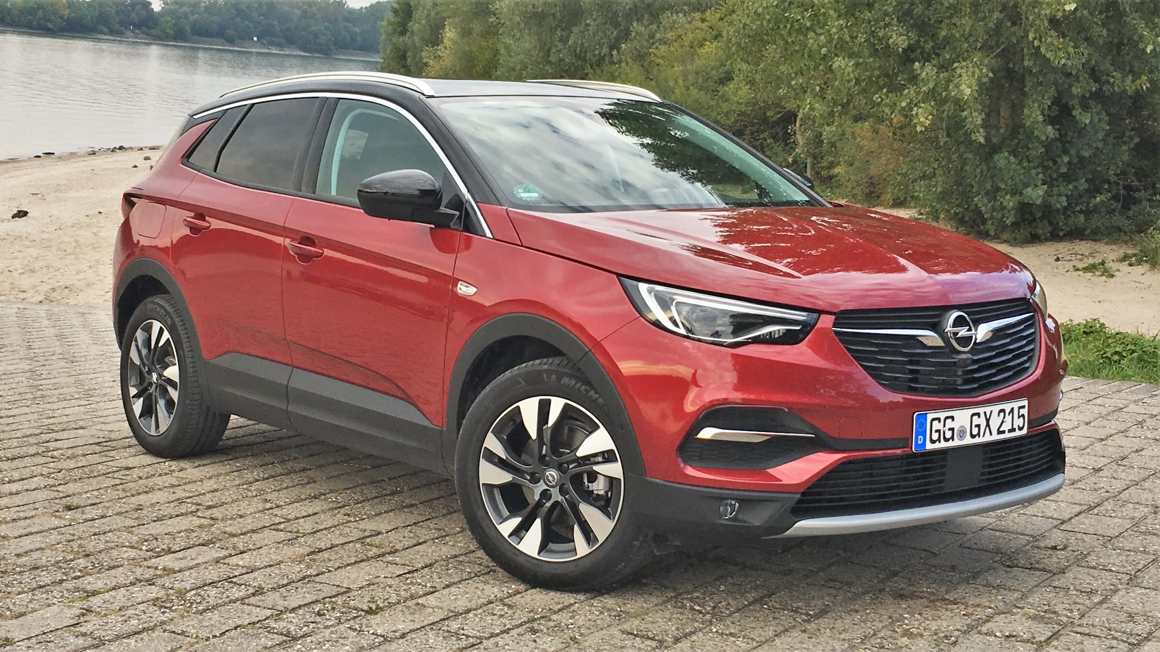 Opel Grandland X, glossy red, cobblestone path, 2K Desktop Wallpaper