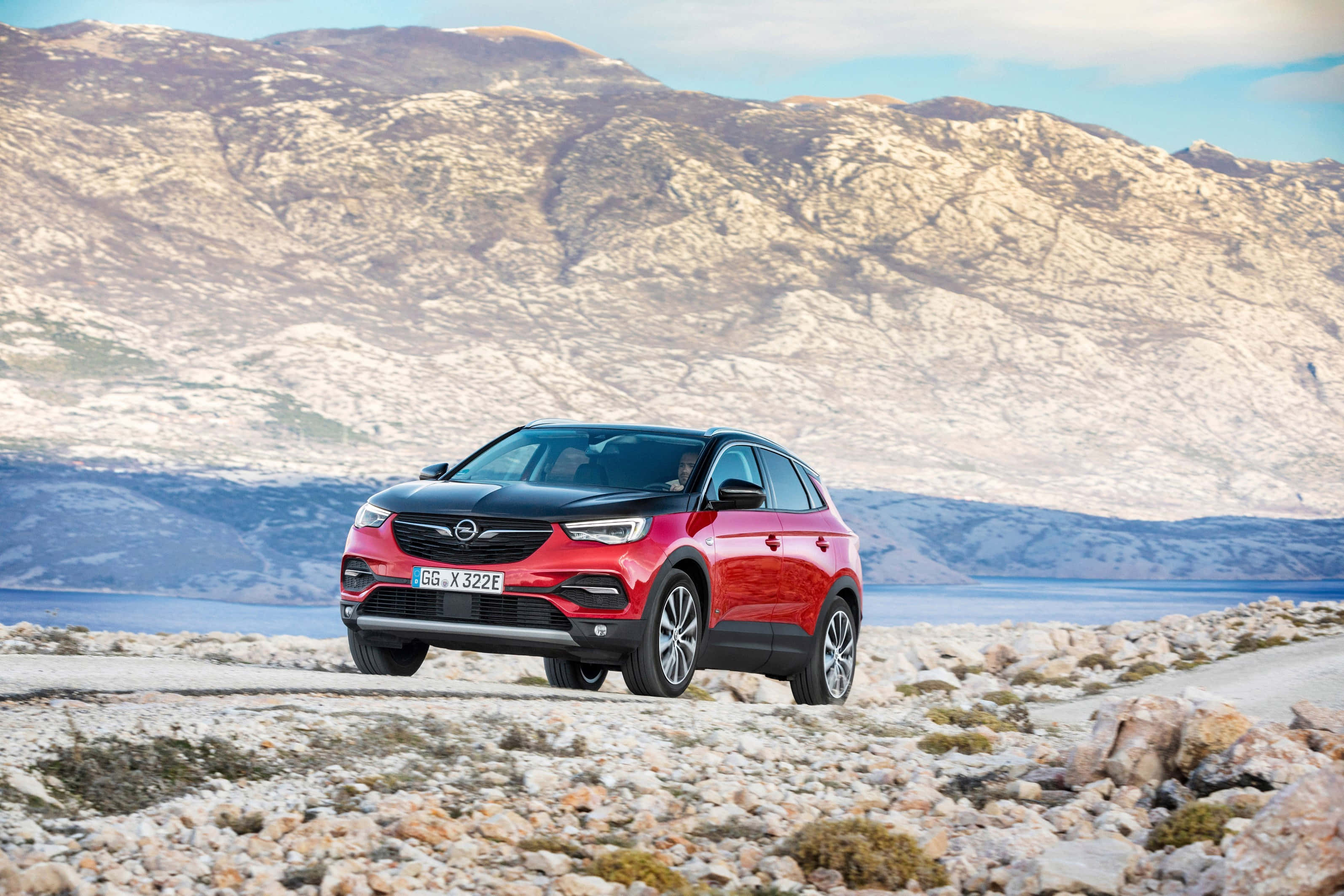 Opel Grandland X, red and black, rocky coastal road, 2K Desktop Wallpaper
