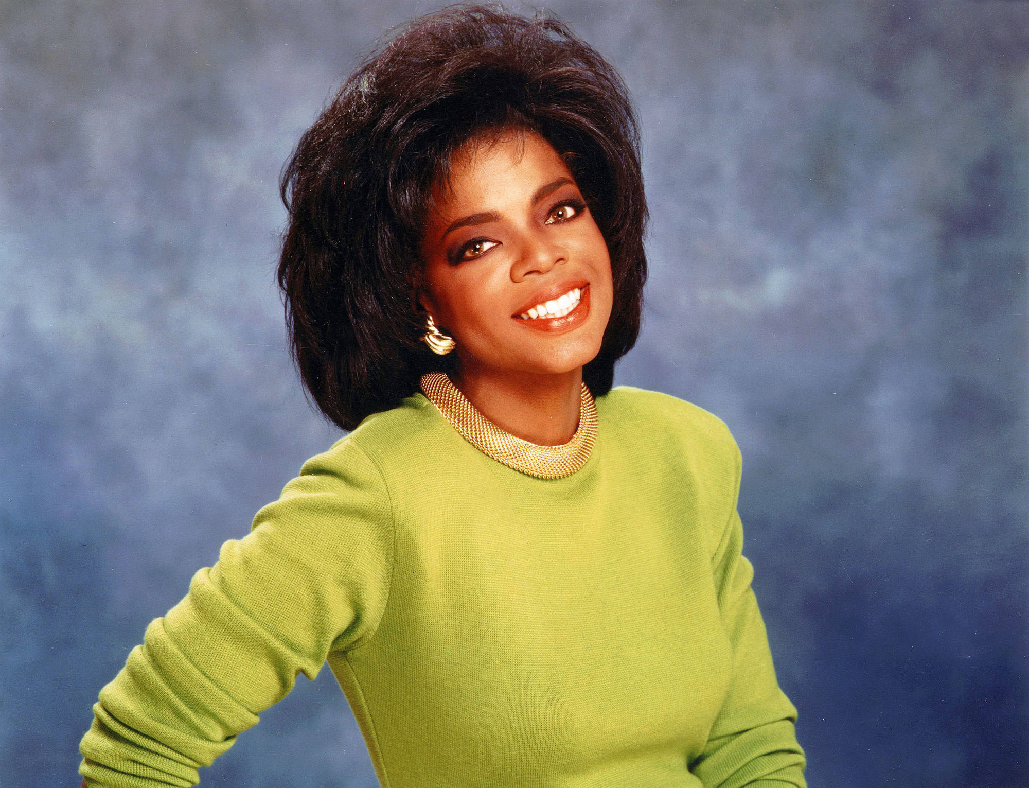 Oprah Winfrey, bright green sweater, textured blue backdrop, Full HD Desktop Wallpaper