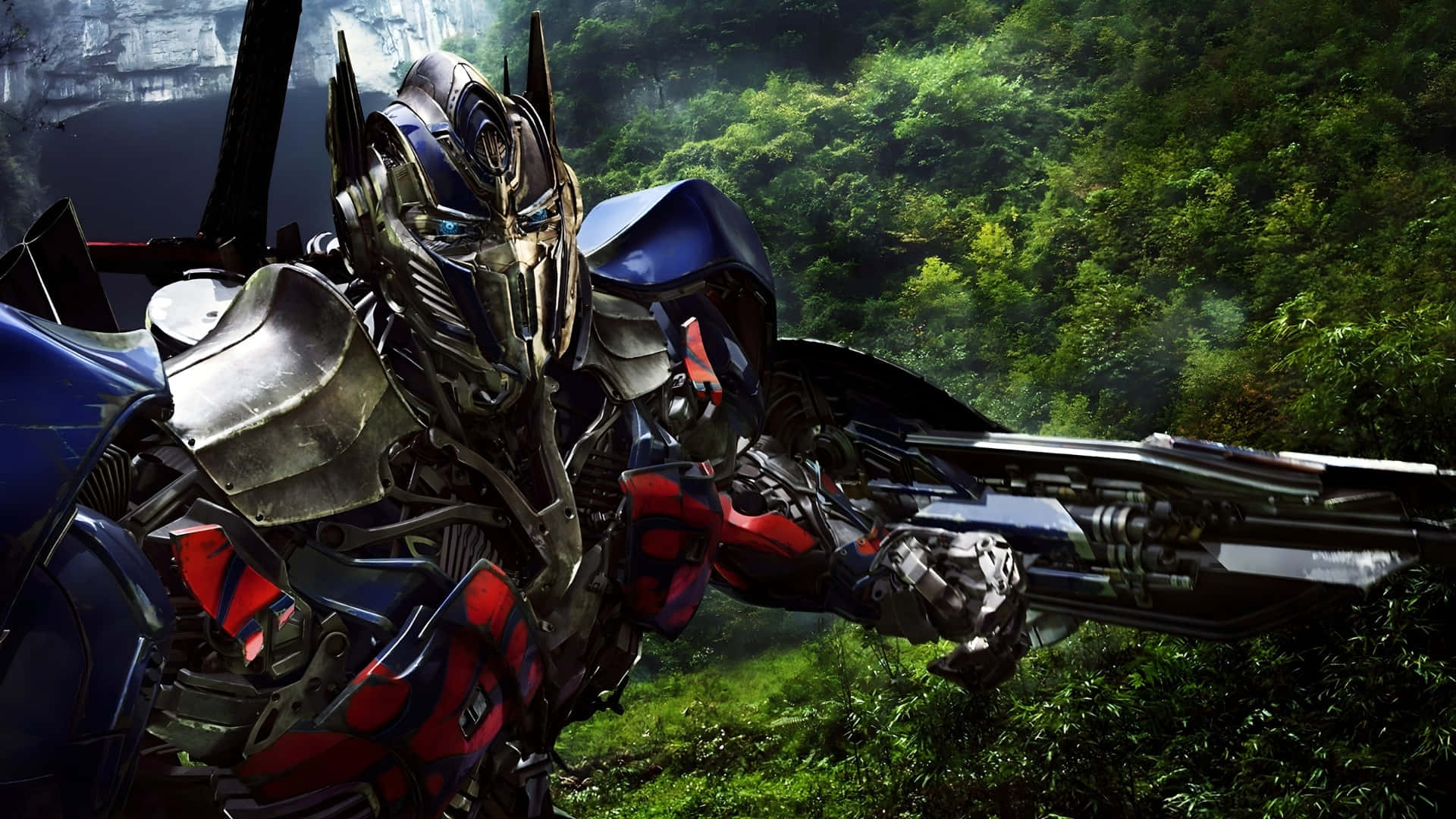 Optimus Prime, lush green forest, large weapon, Full HD Desktop Wallpaper