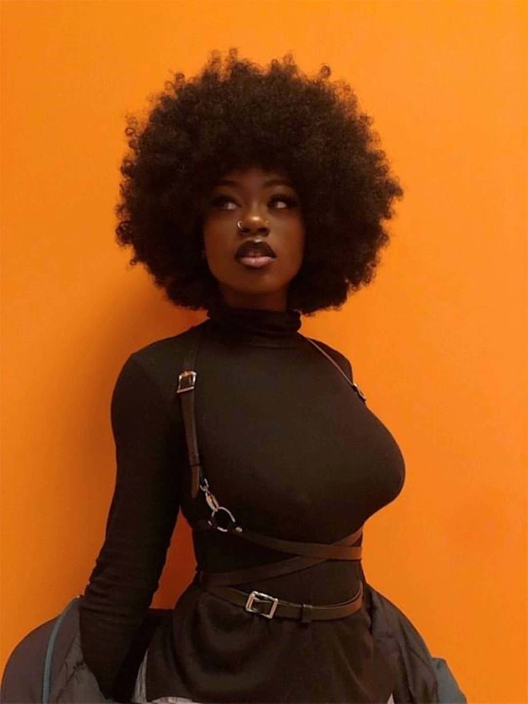 afro hairstyle, vibrant orange wall, black outfit, Full HD Phone Wallpaper