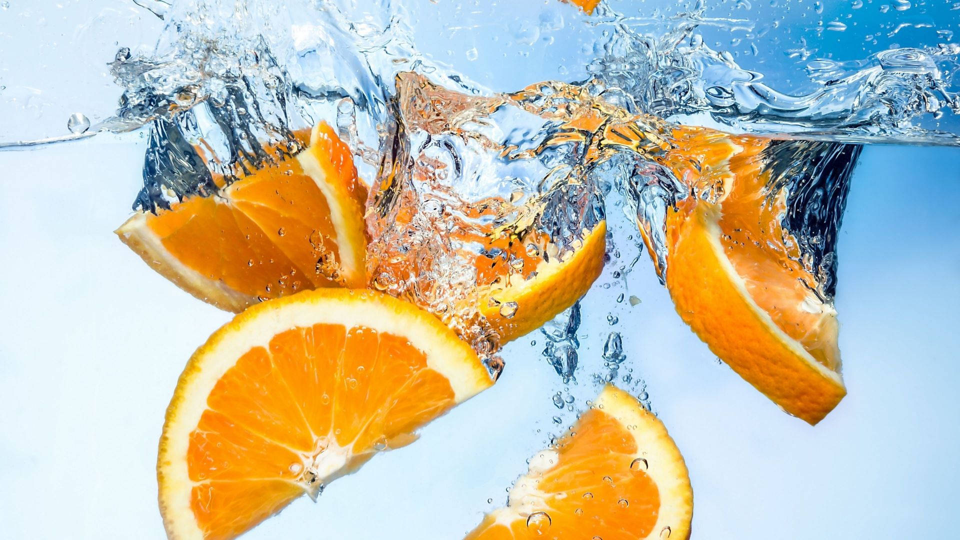 sliced orange fruits, clear water, cool blue background, Full HD Desktop Wallpaper