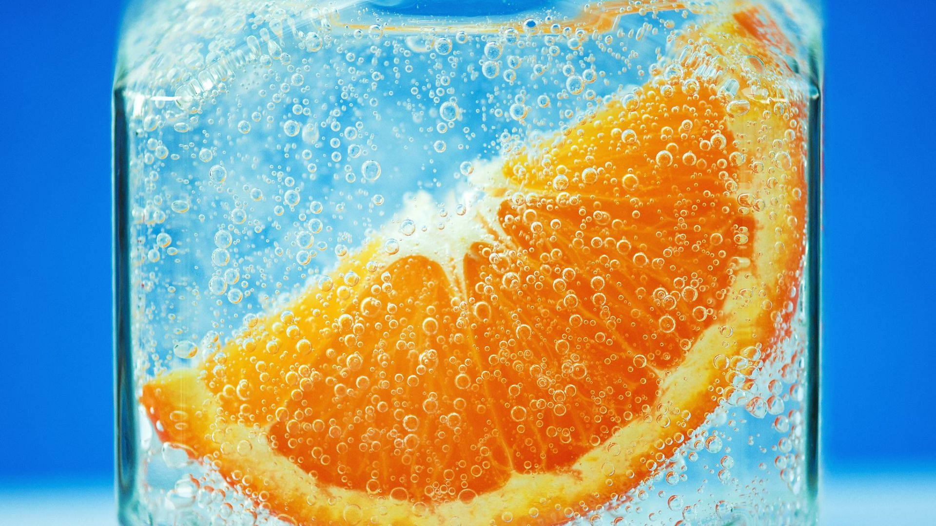 orange slice, sparkling water, vivid blue background, Full HD Desktop Wallpaper