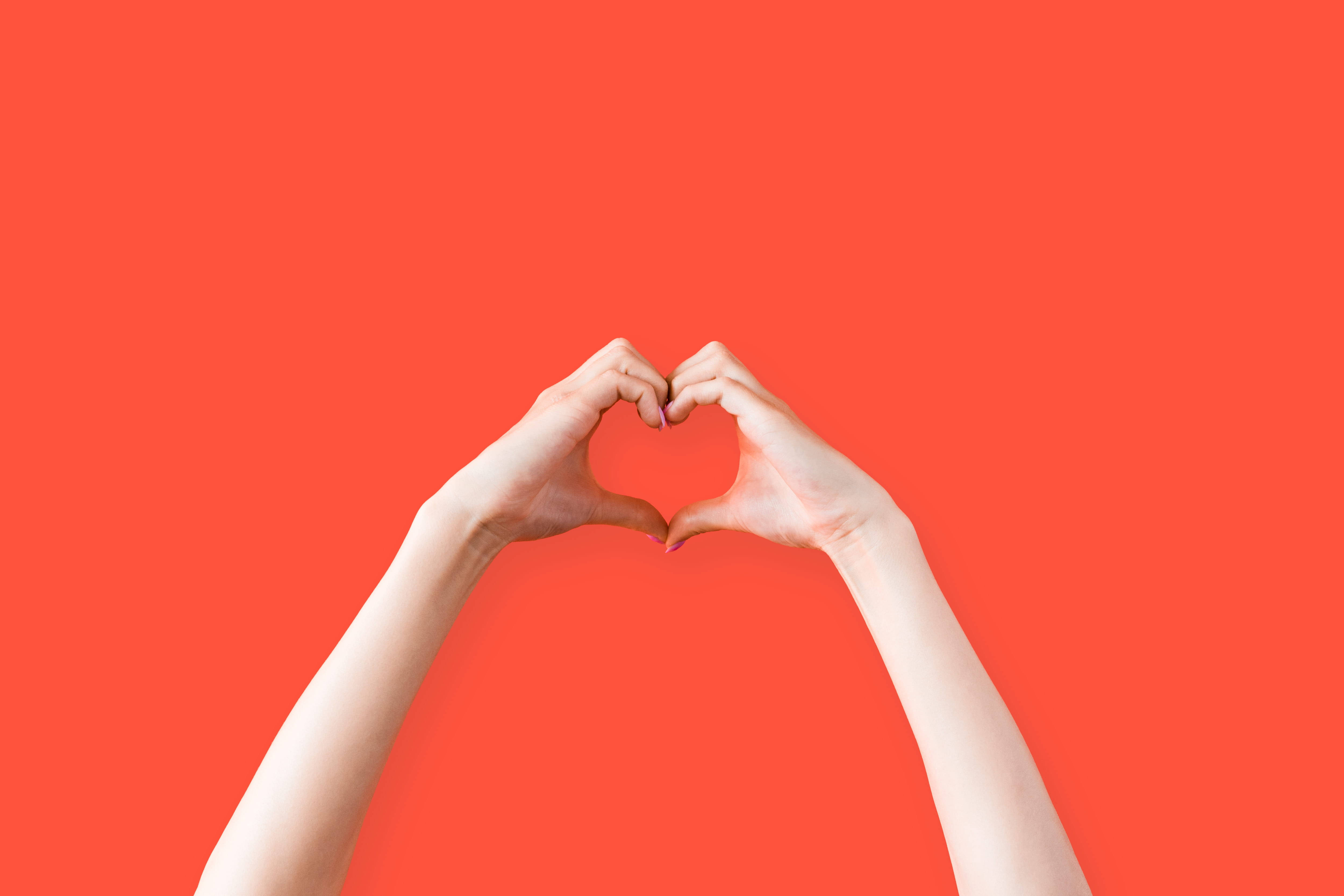 hand heart orange, coral background, minimalist composition, 4K Desktop Wallpaper