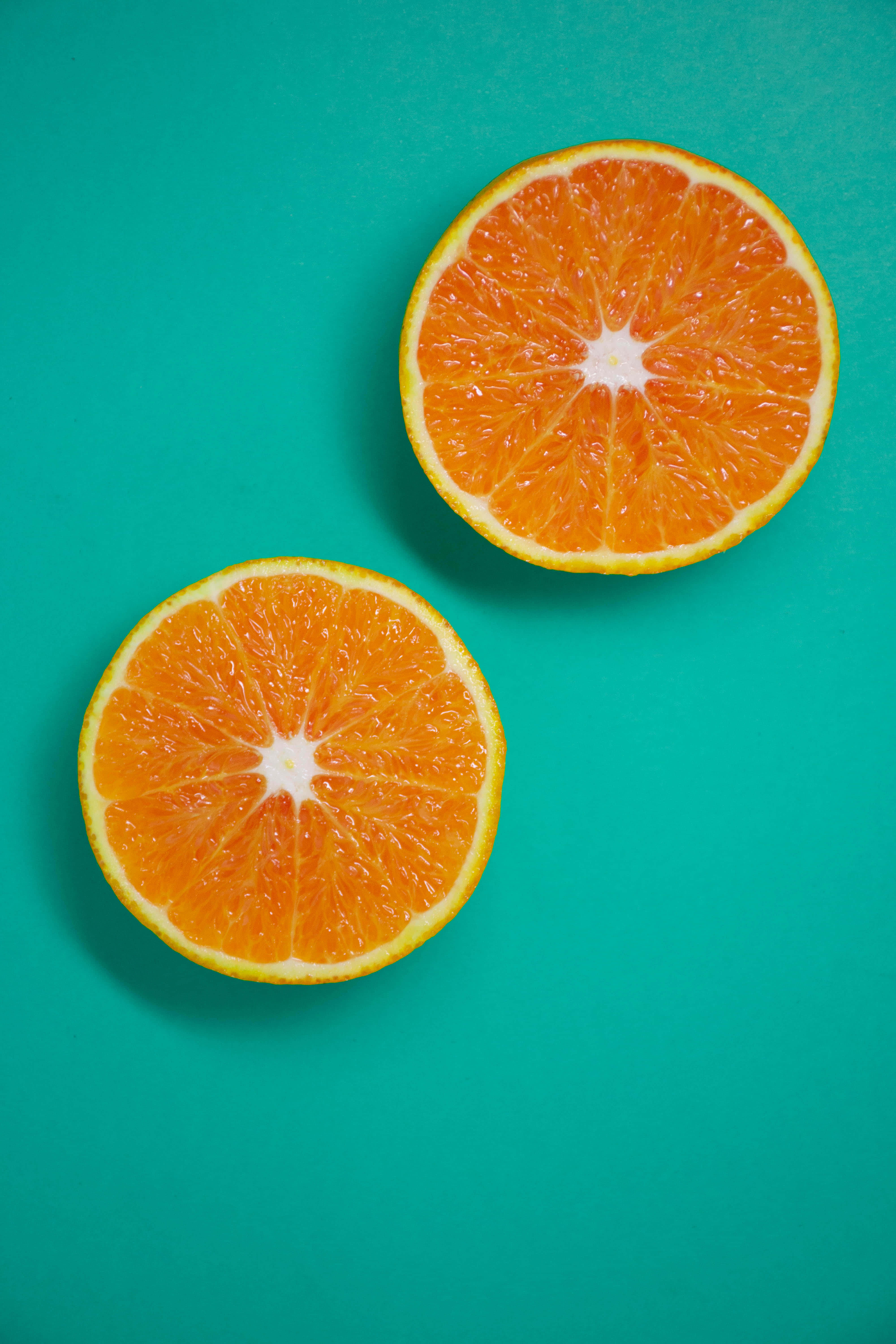 Orange iPhone, vibrant orange, teal background, 5K Phone Wallpaper