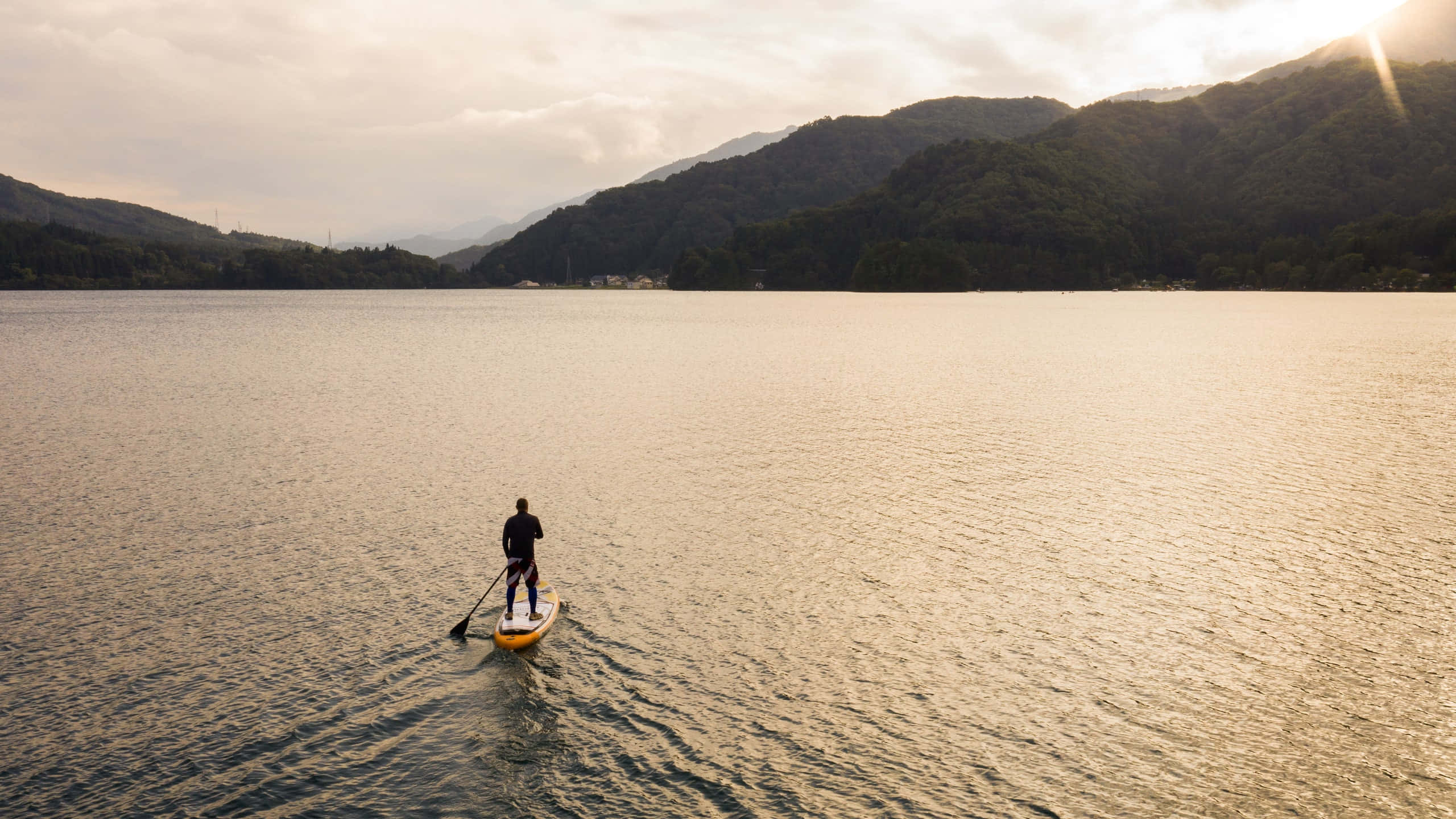 paddleboarder, calm mountain lake, golden sunset, 2K Desktop Wallpaper