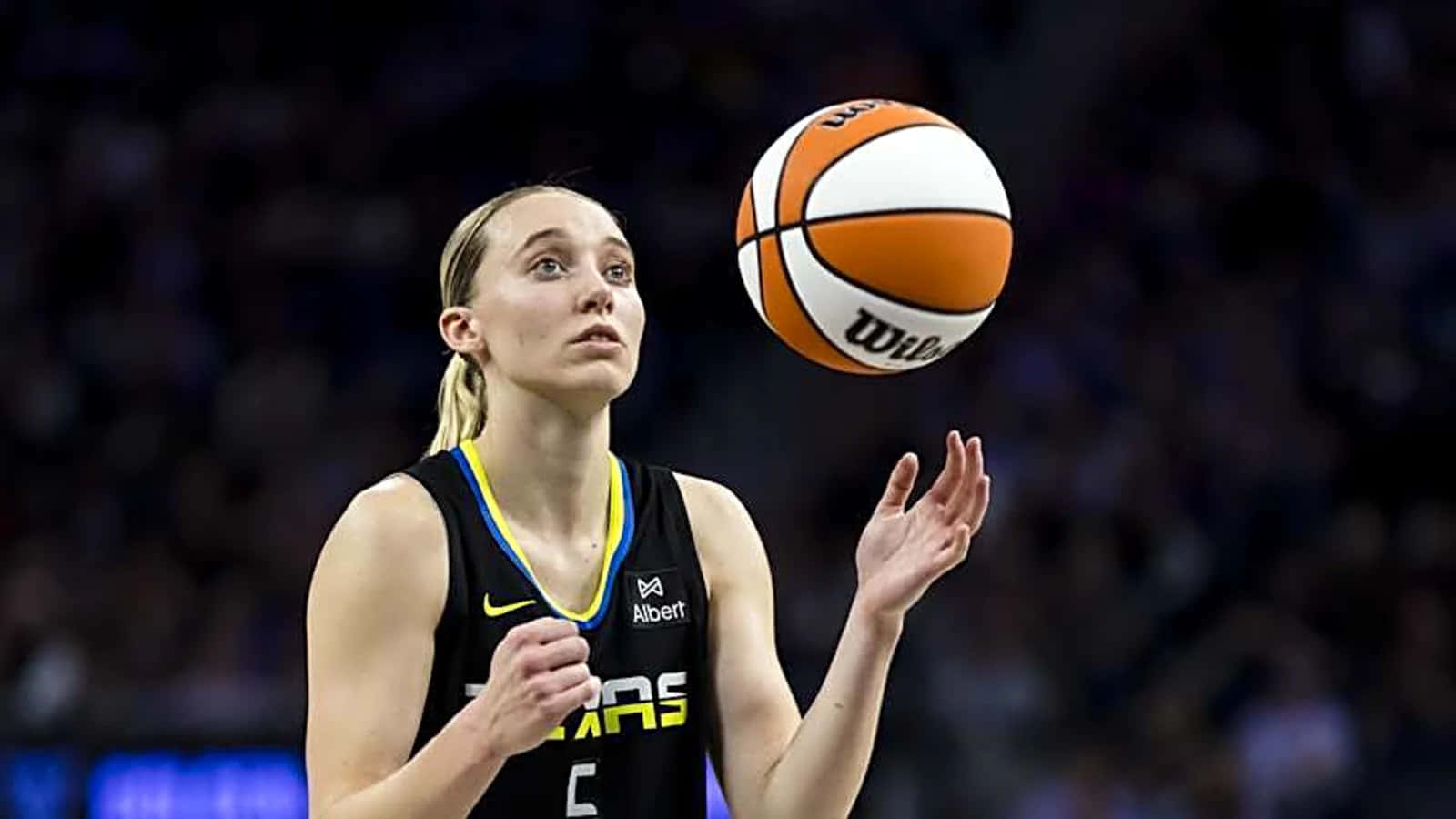 Paige Bueckers, black jersey with yellow trim, orange and white Wilson basketball, HD Desktop Wallpaper