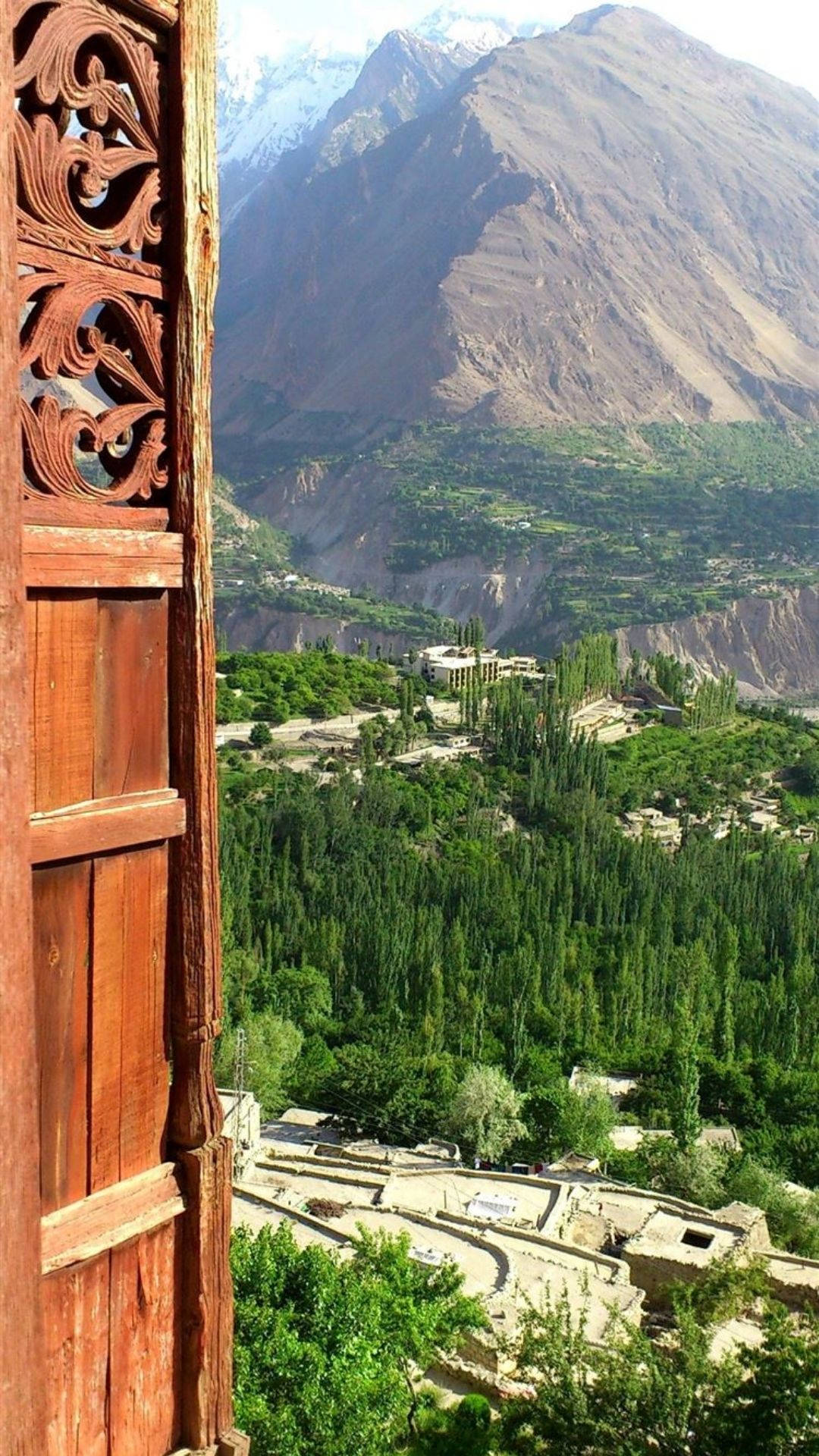 Pakistani valley, snow-capped mountains, carved wooden window, Full HD Phone Wallpaper