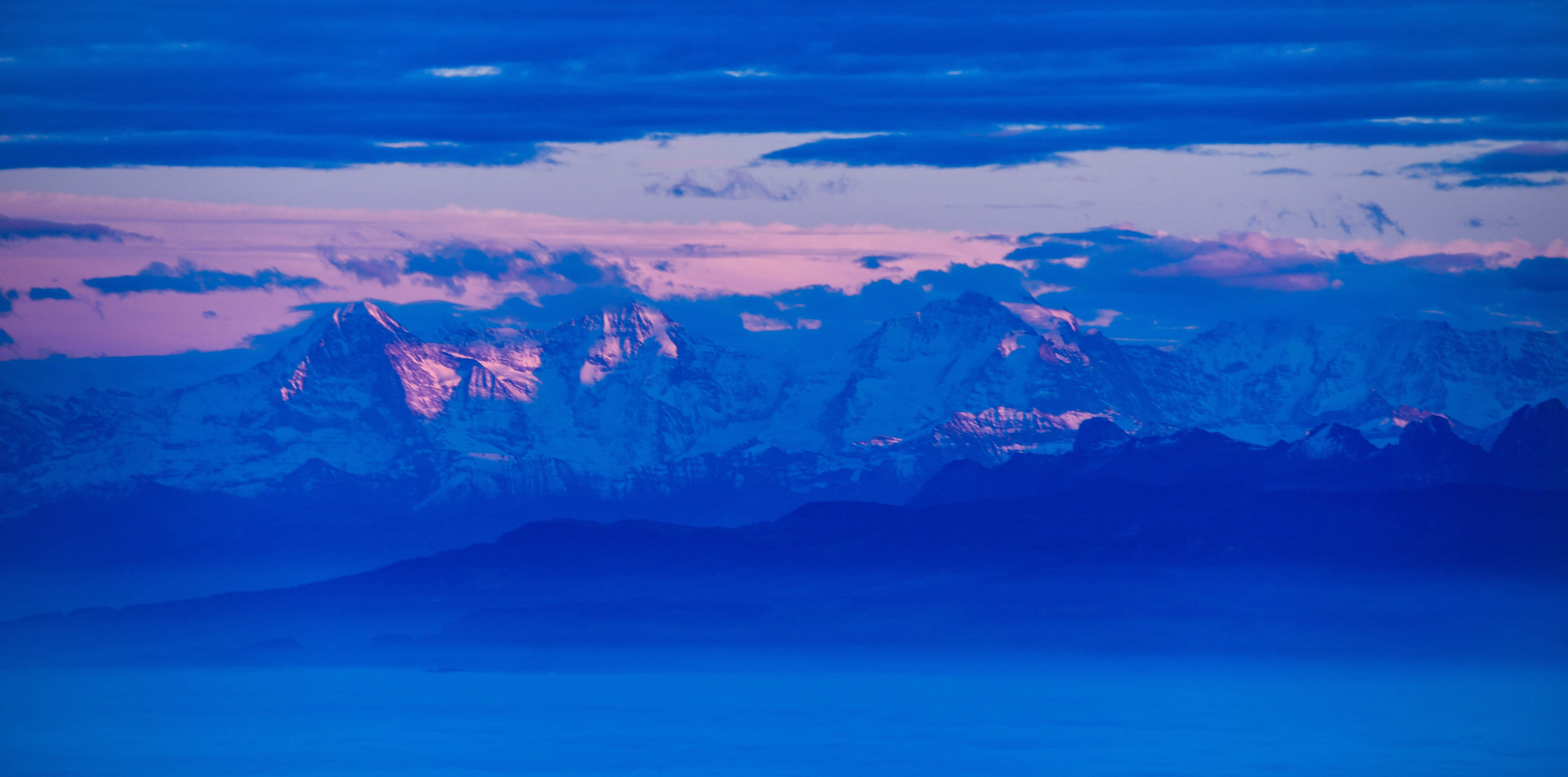 Panoramic Desktop, snowcapped mountain peaks, pink and purple hues, 5K Desktop Wallpaper