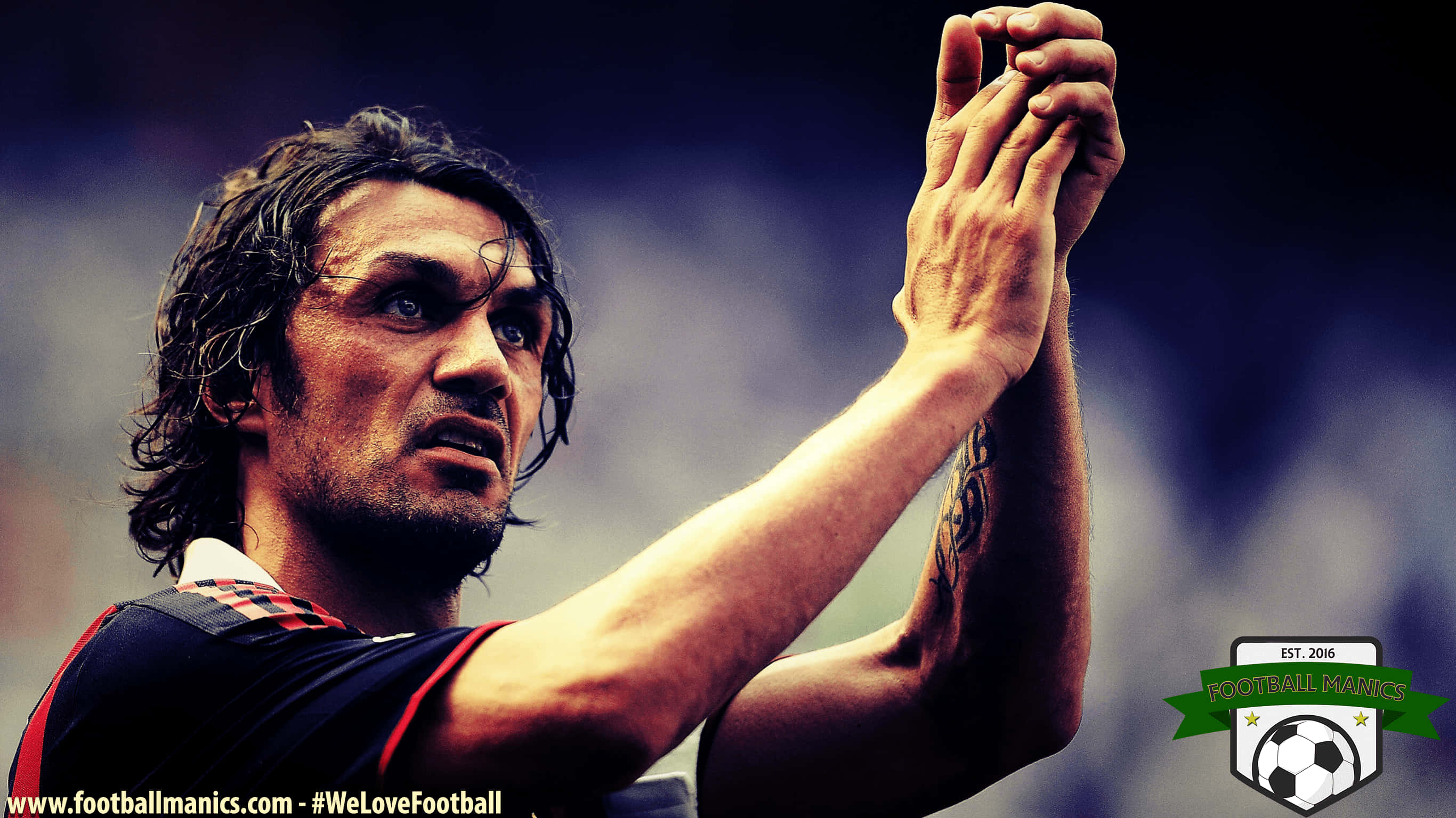 Paolo Maldini, stadium crowd, dramatic lighting, 2K Desktop Wallpaper
