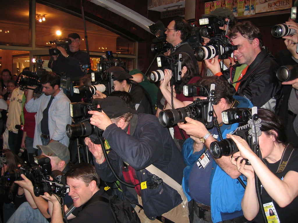 Paparazzi, large cameras, dimly lit indoor space, SD Desktop Wallpaper