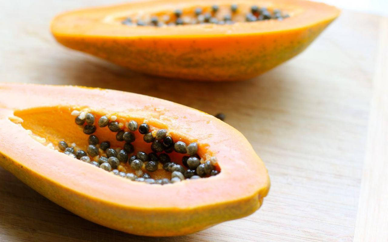 fresh papaya fruit, light wooden surface, vibrant orange flesh, HD Desktop Wallpaper