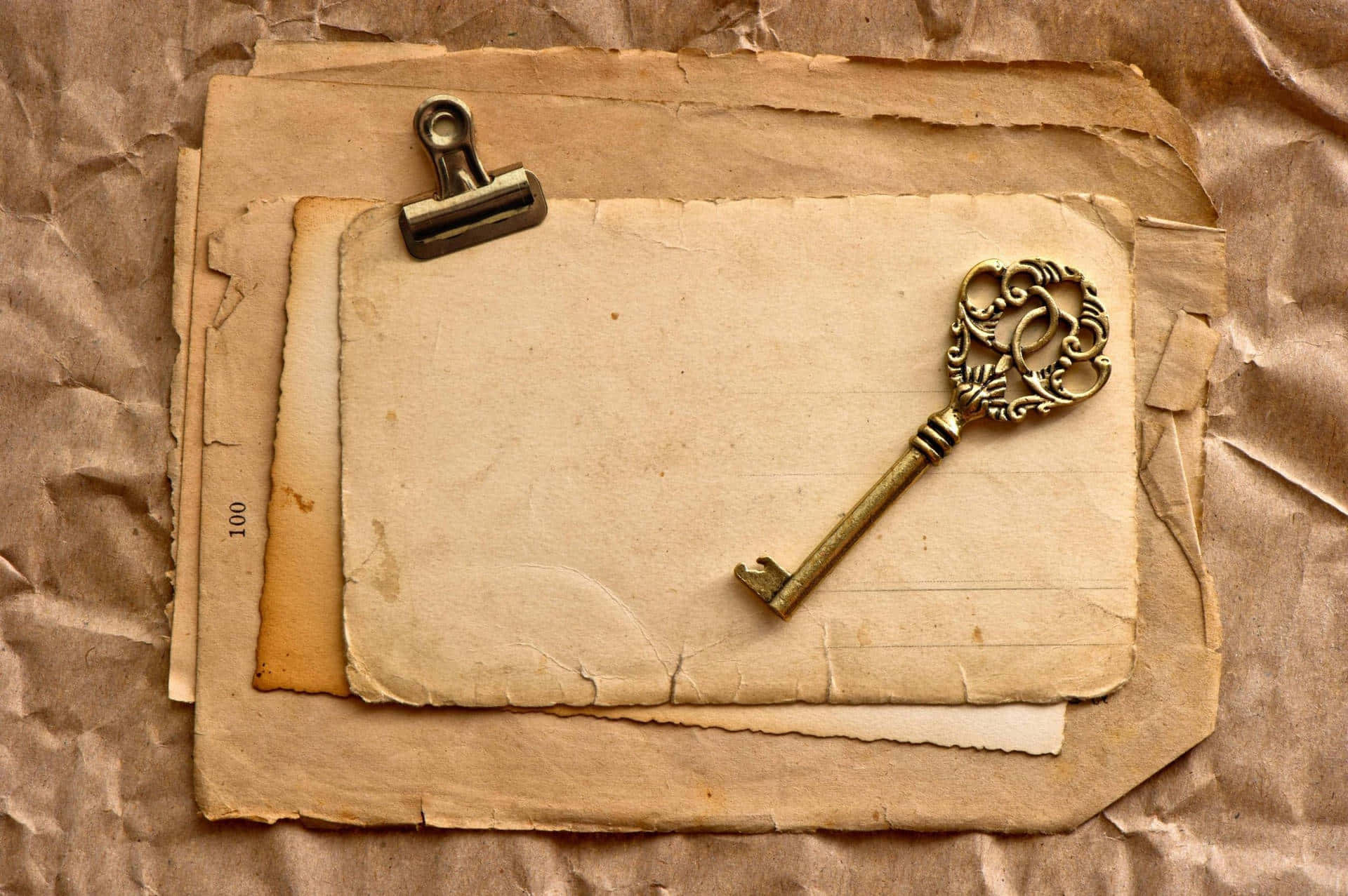 vintage layered paper background, ornate brass key, aged parchment papers, Full HD Desktop Wallpaper