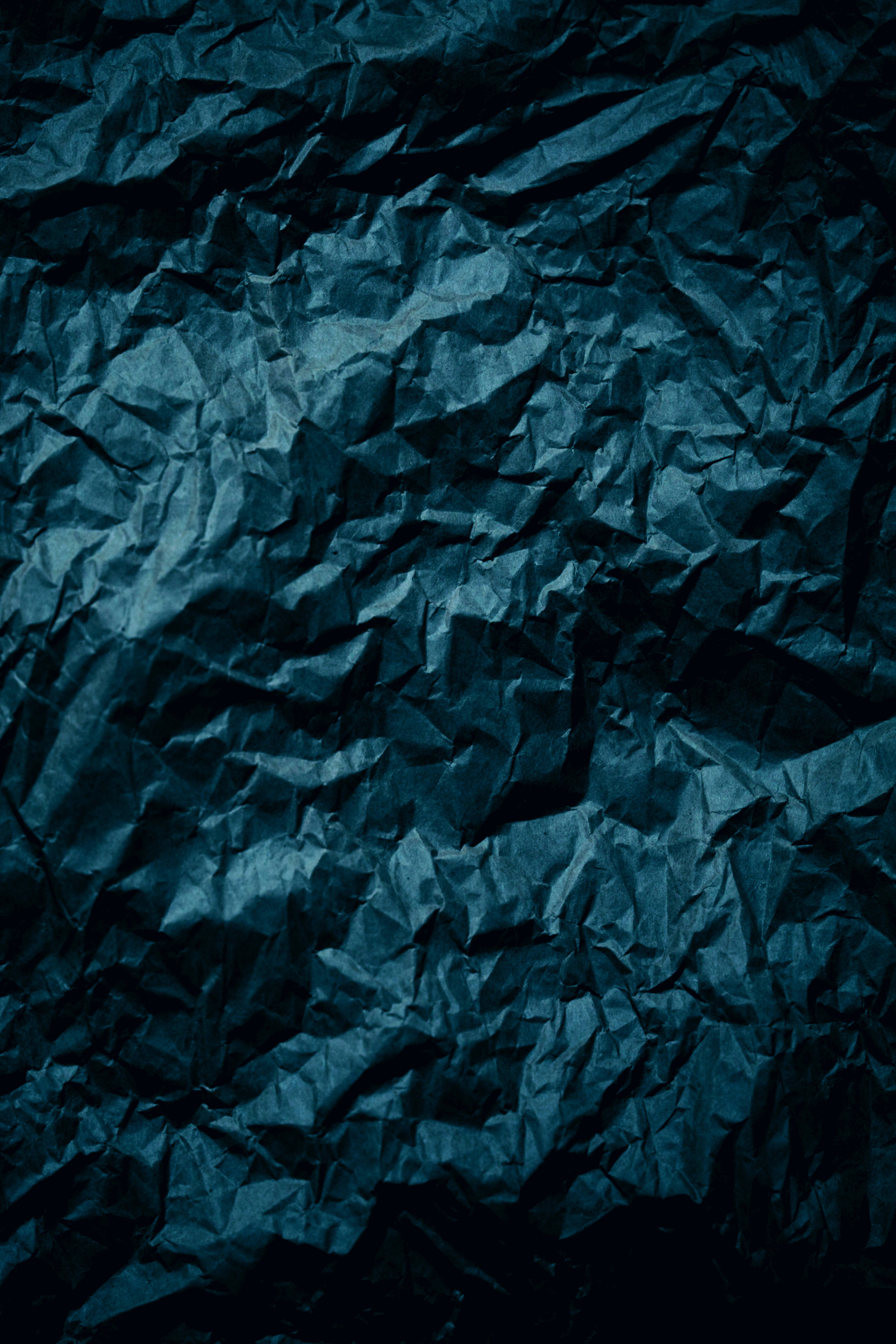 deep blue, crumpled paper texture, dramatic shadows, 5K Phone Wallpaper