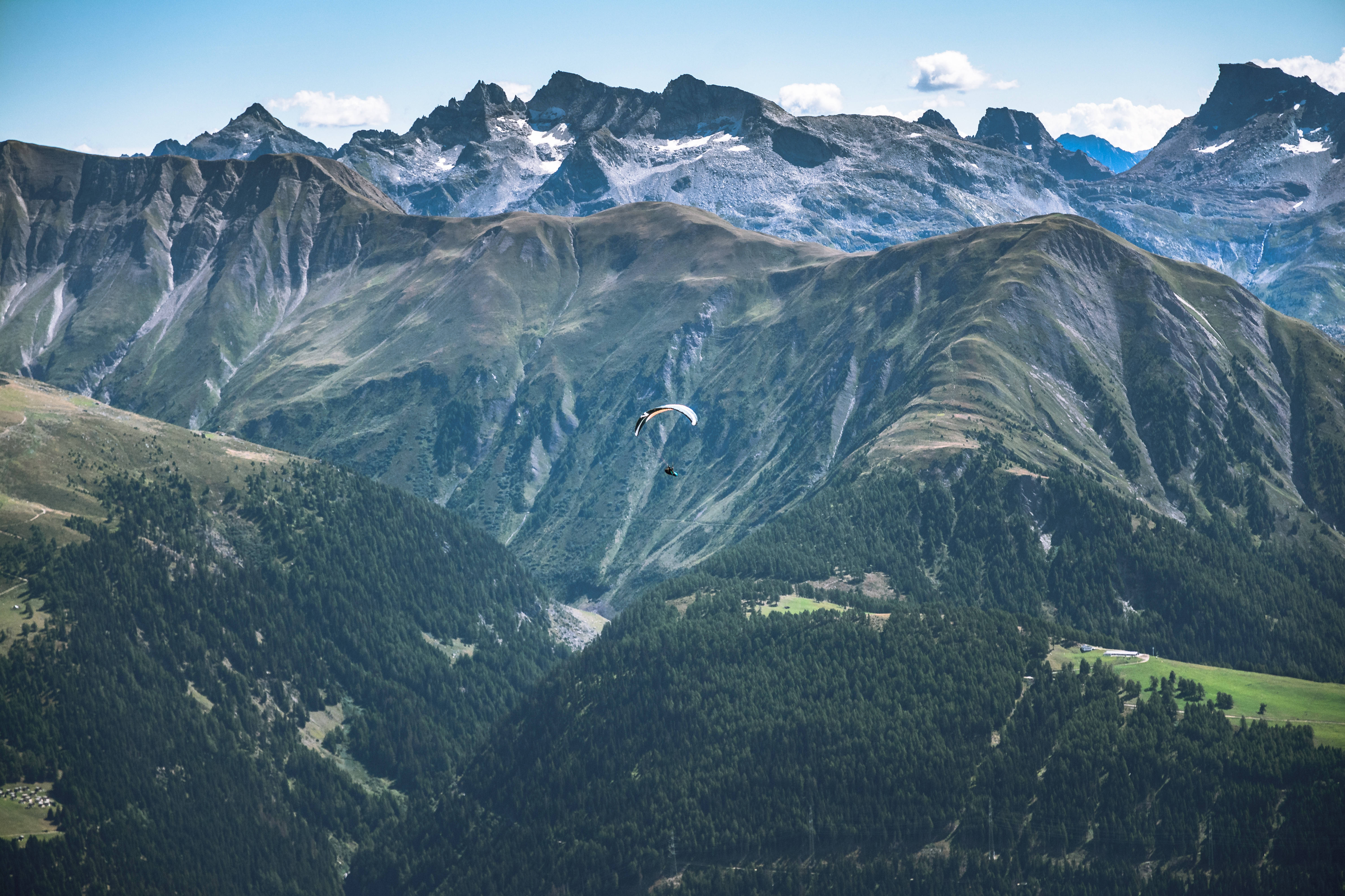 verdant mountain ranges, snow-capped peaks, dense forests, 5K Desktop Wallpaper