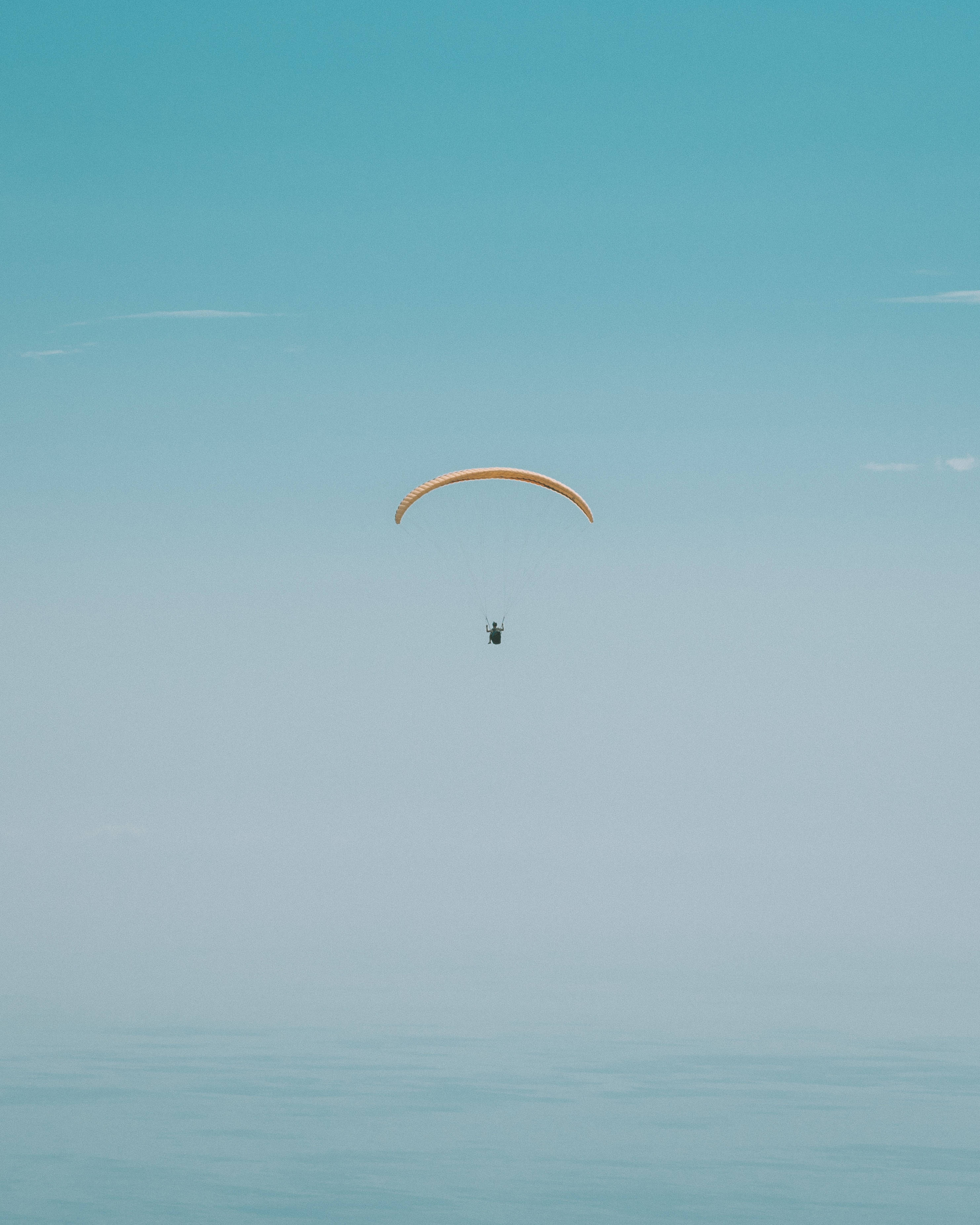 paragliding, tan canopy, calm turquoise sea, 2K Phone Wallpaper